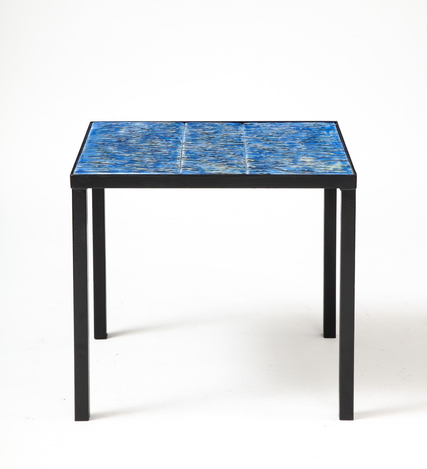 Modern, minimalist side table with seamlessly integrated expressive hand-painted tiles.