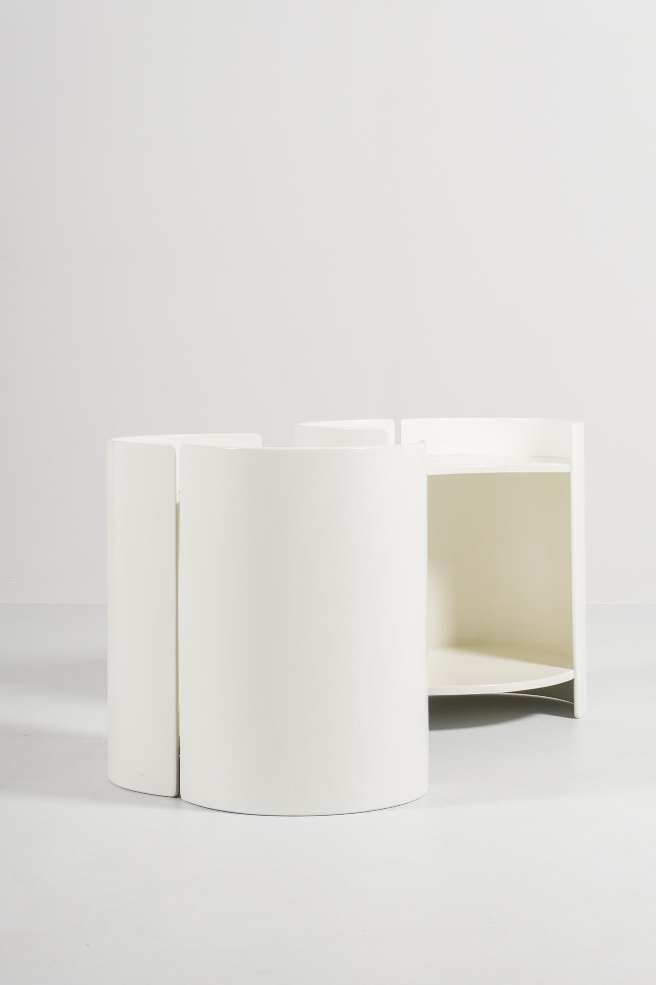 The two rotating flexible side tables, model GEA, made of white lacquered plywood, were designed by Kazuhide Takahama in 1961. They can act as side tables as well as bedside tables, the main body is placed on a cylindrical base.
Takahama is best