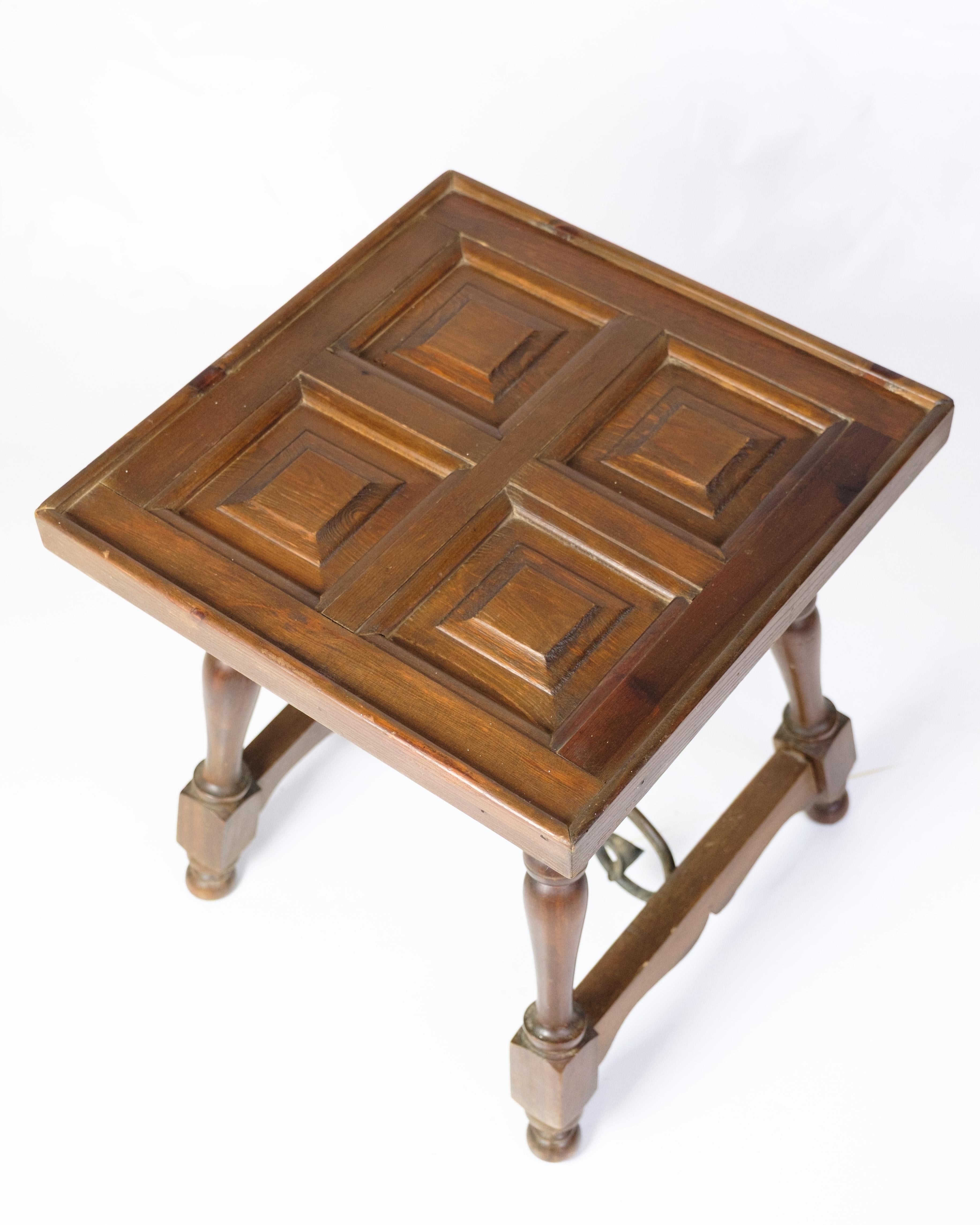 Dark wood side table with paneled top in geometric pattern. The table stands on turned legs connected by curved metal struts for extra stability.

Dimensions: H:43cm W:40cm D:40cm