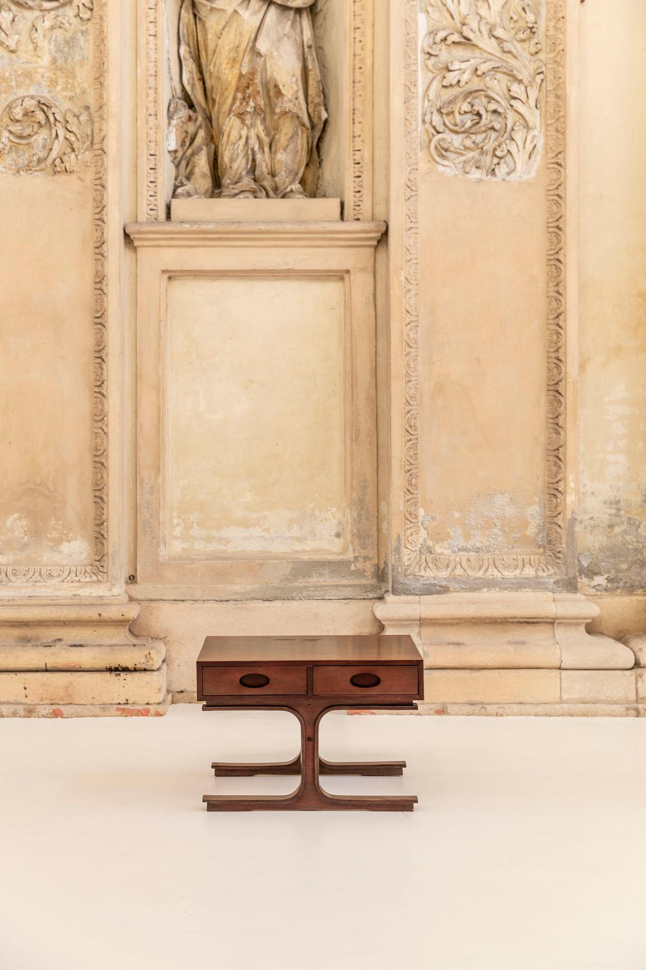 Side table or bedside table or coffee table designed by Gianfranco Frattini in 1957 for Bernini, model 554. Made of wood, the table has two drawers with handles carved and two iconic central legs with wide foothold.

 