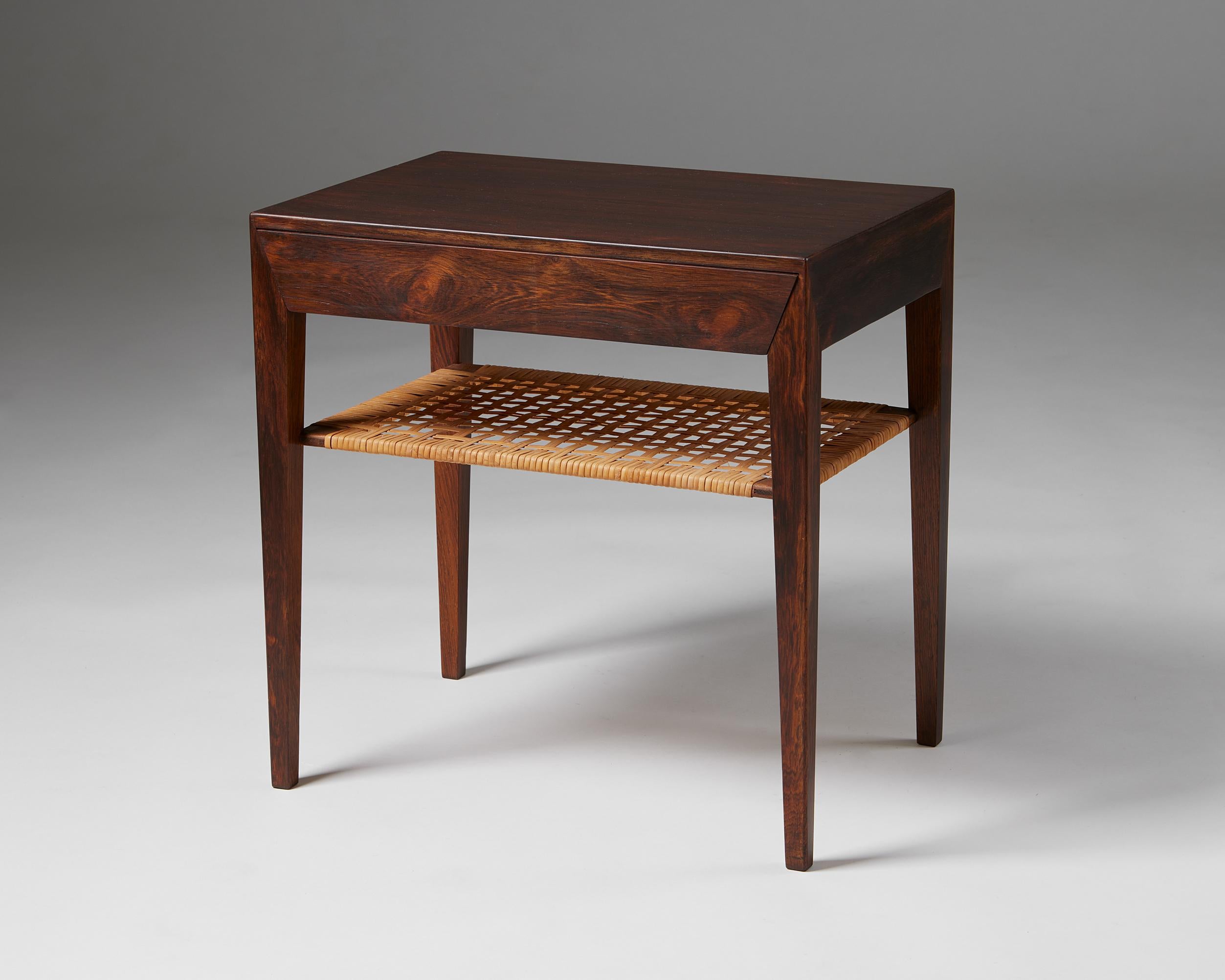 Side table model 35 designed by Severin Hansen Jr for Haslev Mobelfabrik,
Denmark. 1950s.

Rosewood and cane.

Stamped.

Severin Hansen's model 35 from the 1950s has two practical surfaces and an elegant pullout drawer. It was produced by the