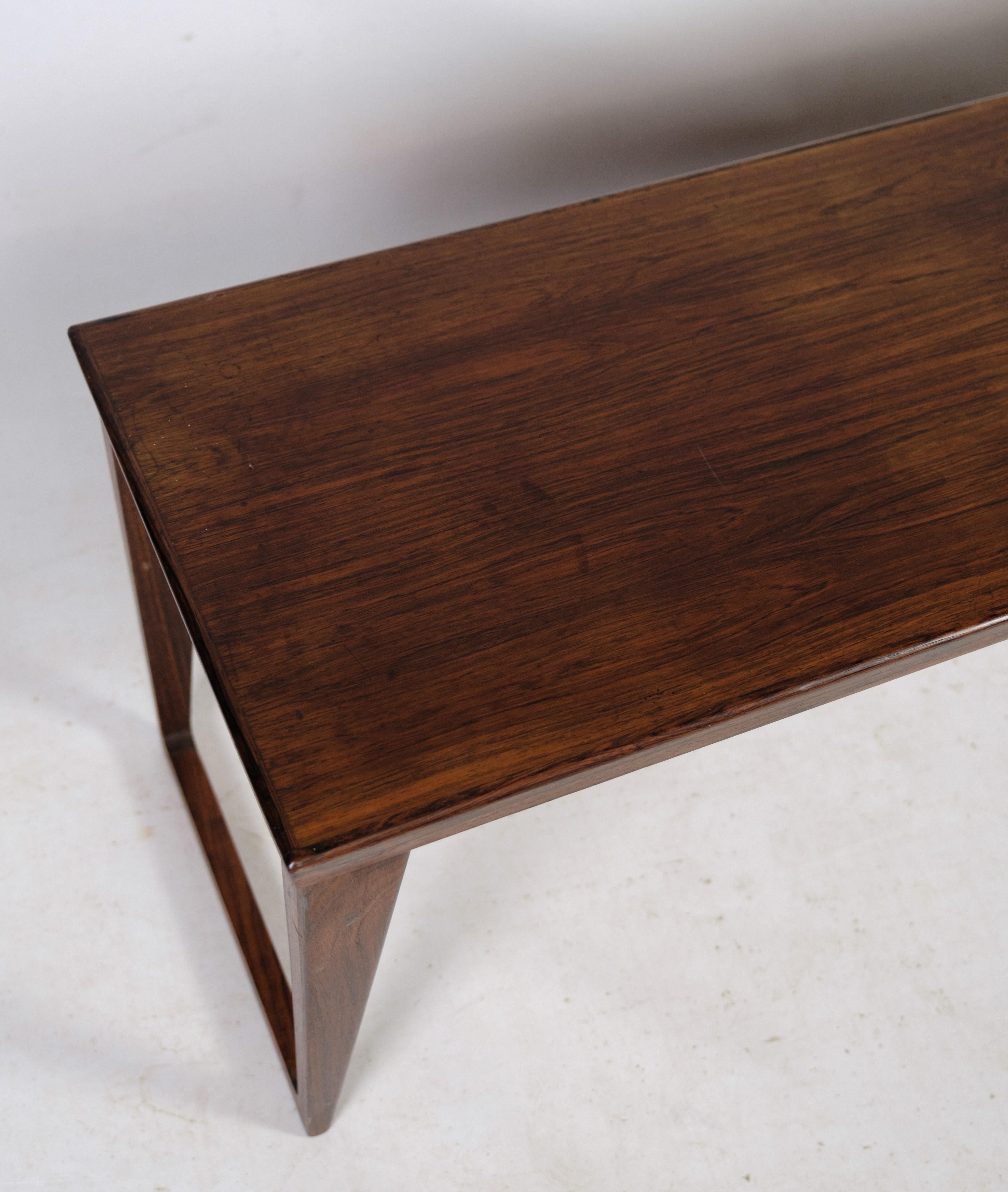 This beautiful minimalist low bench or side table was designed by Kai Kristiansen for Aksel Kjersgaard in Denmark in the 1960s. The model is called no. 36 and is made of rosewood.

The bench's simple design and clean lines give it an elegant and