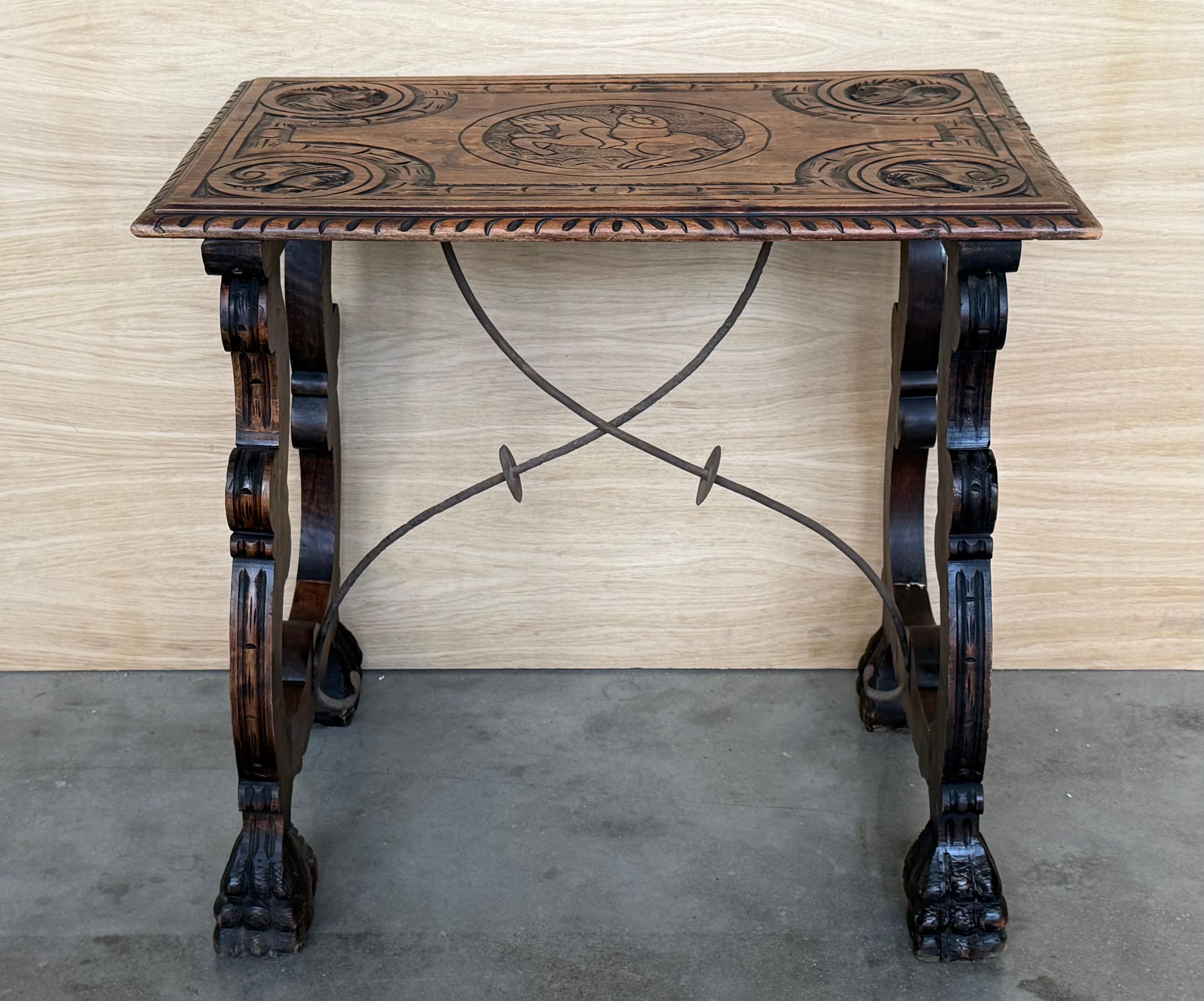 Side table of walnut with carved lyre legs with carved top with horse and cavaliers and so carved edges in top. Beautiful iron stretcher, Spanish, 19th century.