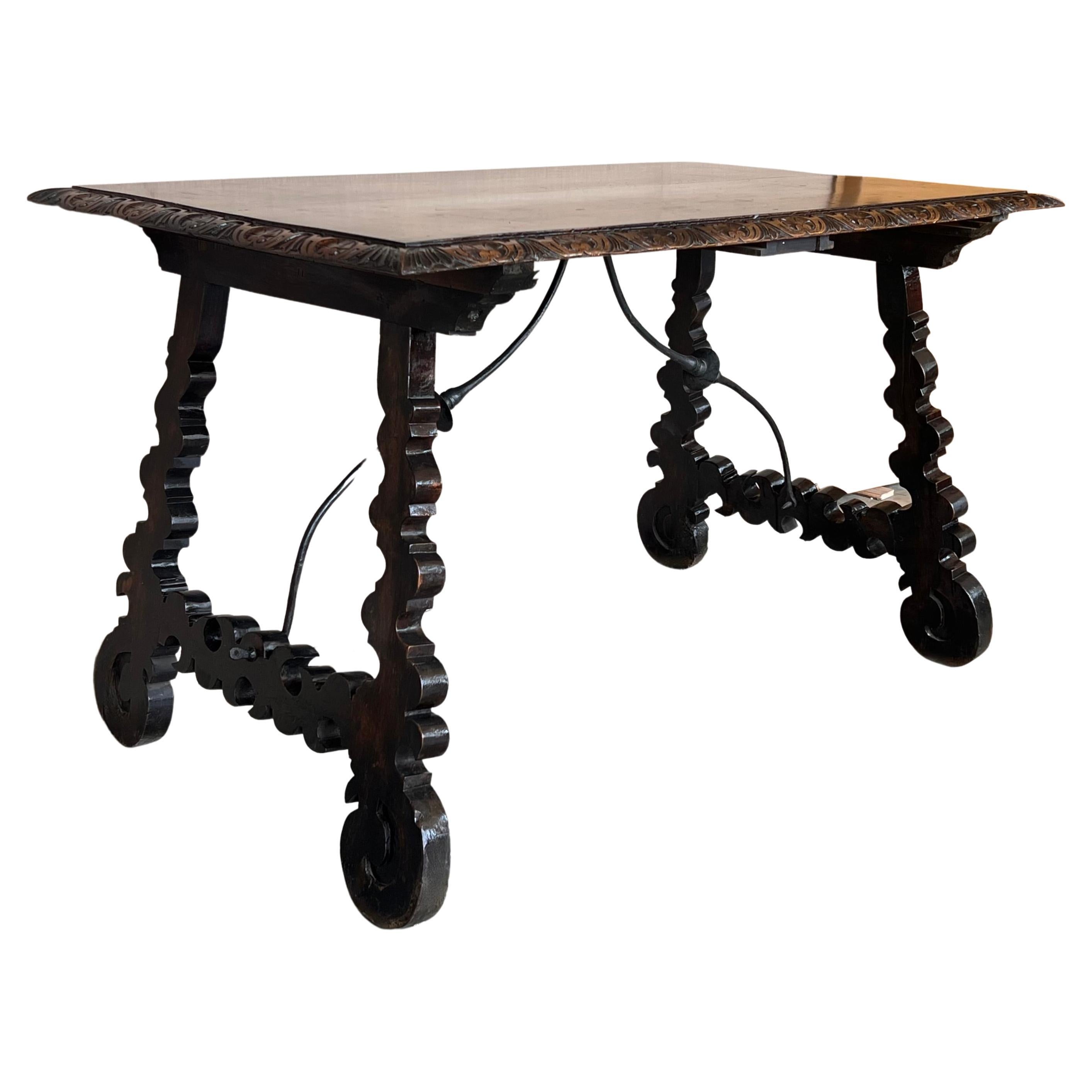 Side table of walnut with carved lyre legs .
The top is finely carved edges. 
Beautiful and original iron stretcher, Spanish, 19th century.
