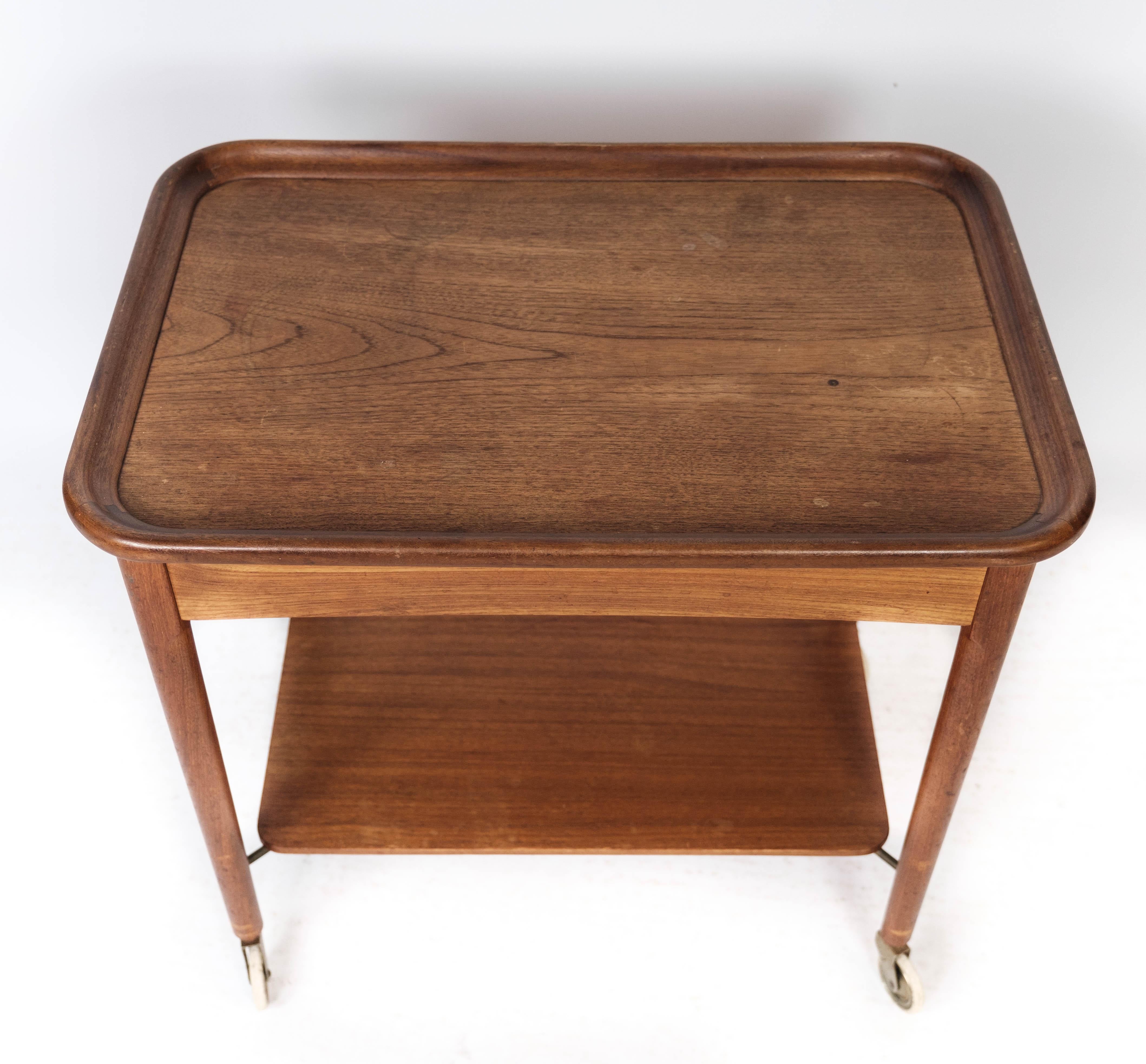 
This teak side table from the 1960s exudes the quintessential charm of Danish design. Its simple yet elegant silhouette makes it a versatile addition to any space, offering both style and functionality.

Crafted from teak, known for its durability