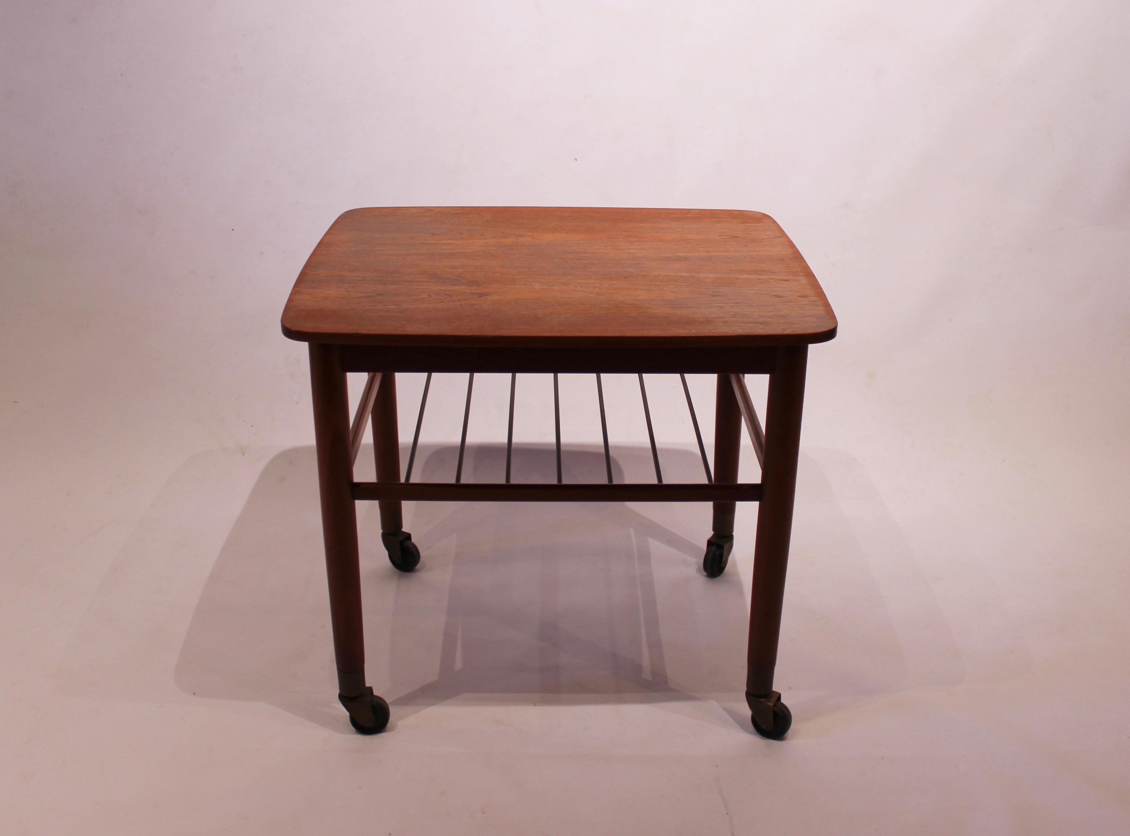 Side table on wheels with shelf of teak and of Danish design from the 1960s. The table is in great vintage condition.