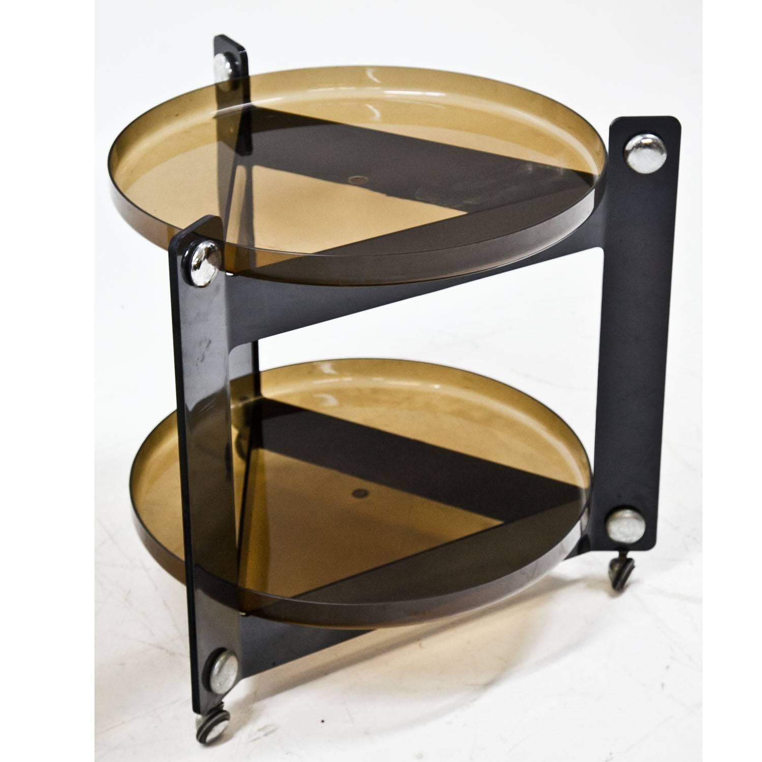 1960s side table on wheels with two round trays out of brown plastic.