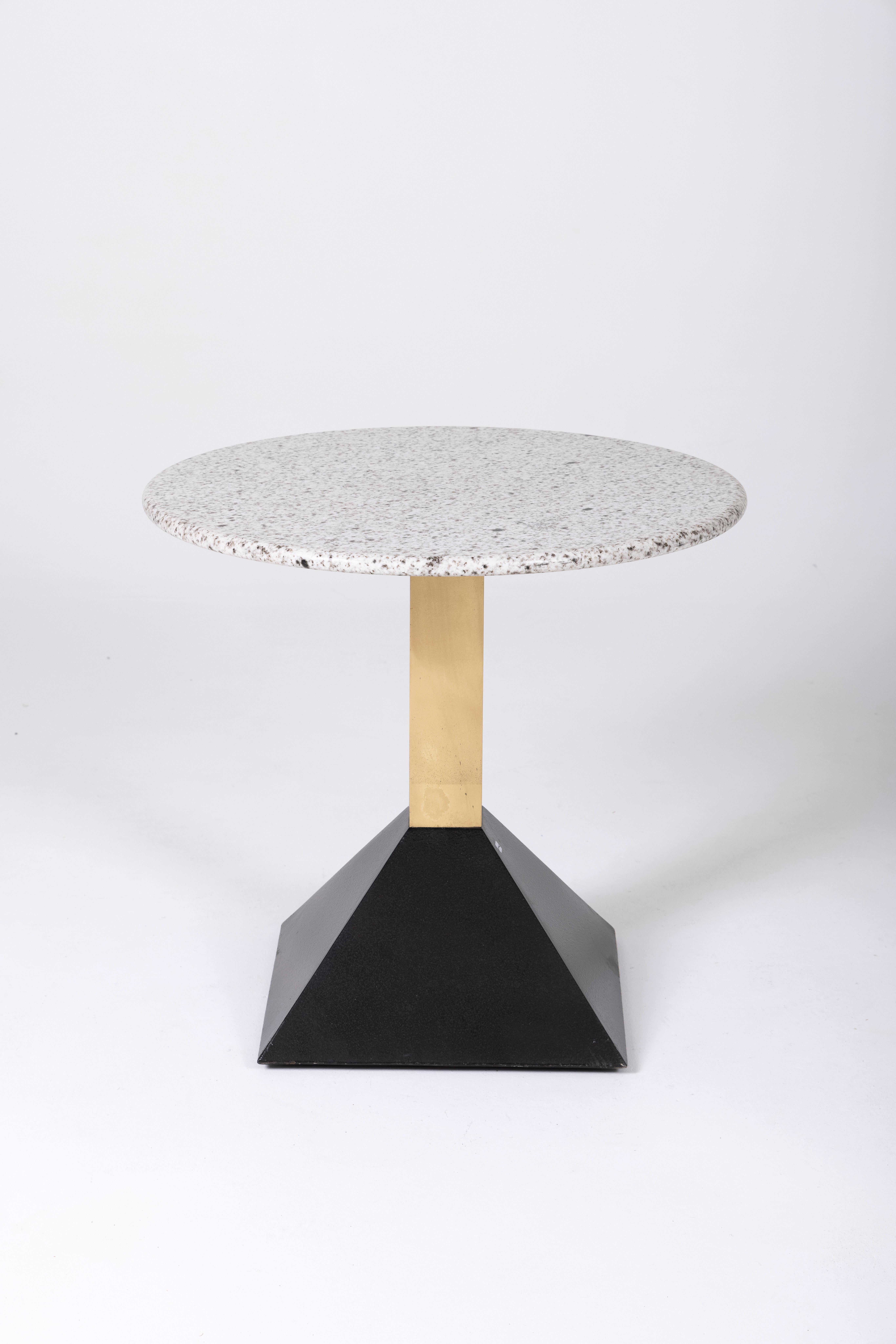 Terrazzo and brass side table from the 1980s. The tabletop is made of white and gray marble, while the base is crafted from black lacquered metal and brass. This pedestal table complements Memphis-style furniture.
DV148
