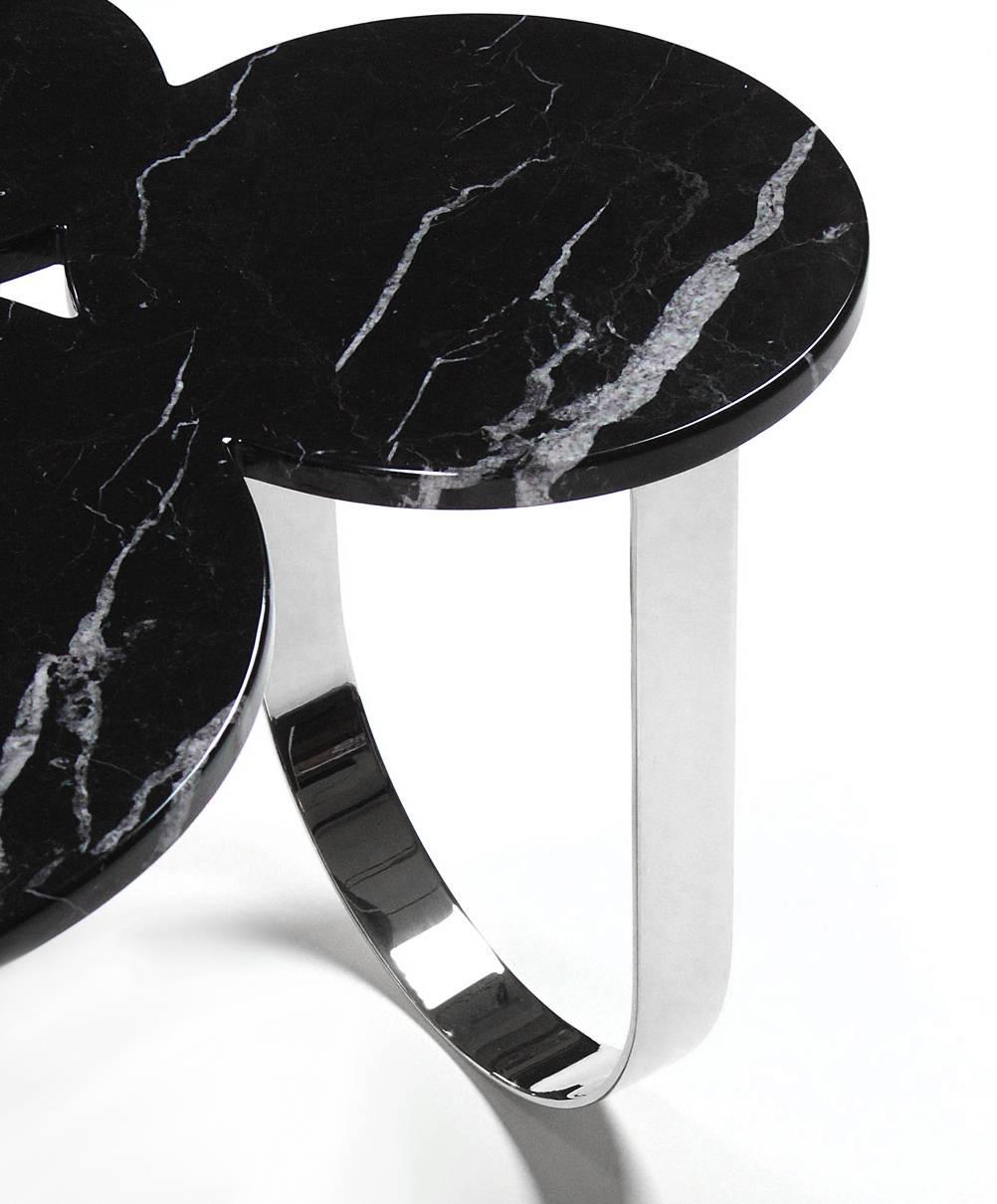 The 'Cloud' is a spectacular side table with structure in mirror polished stainless steel and top in Marquinia marble. The mirror-like finishing of the stainless steel creates different perceptions of this particular material and allows interesting