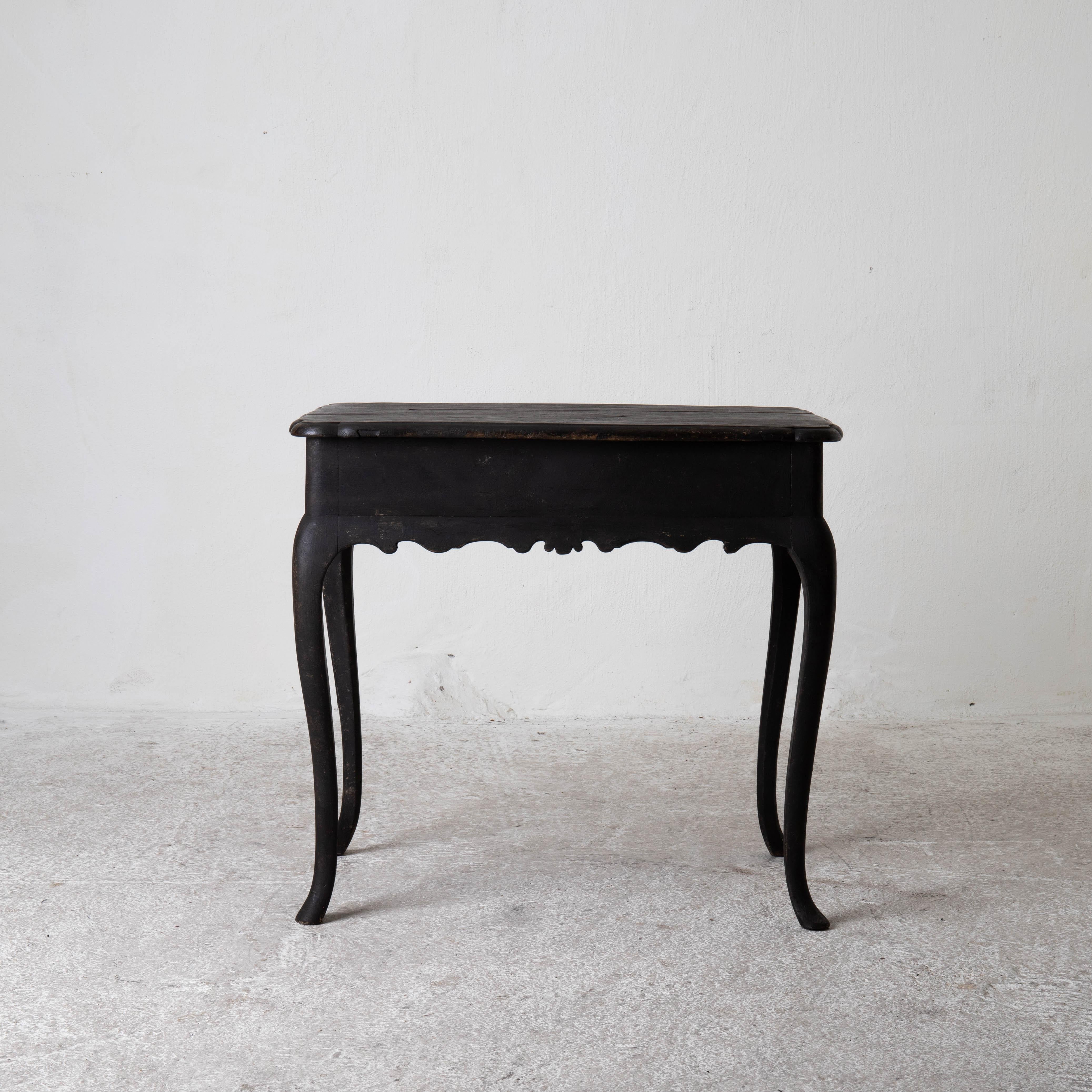 Side table Swedish Rococo black Sweden. Side table Rococo period 1750-1775 refinished in our Laserow Black. Wavy frieze and S shaped legs. Rounded corners on the table top.