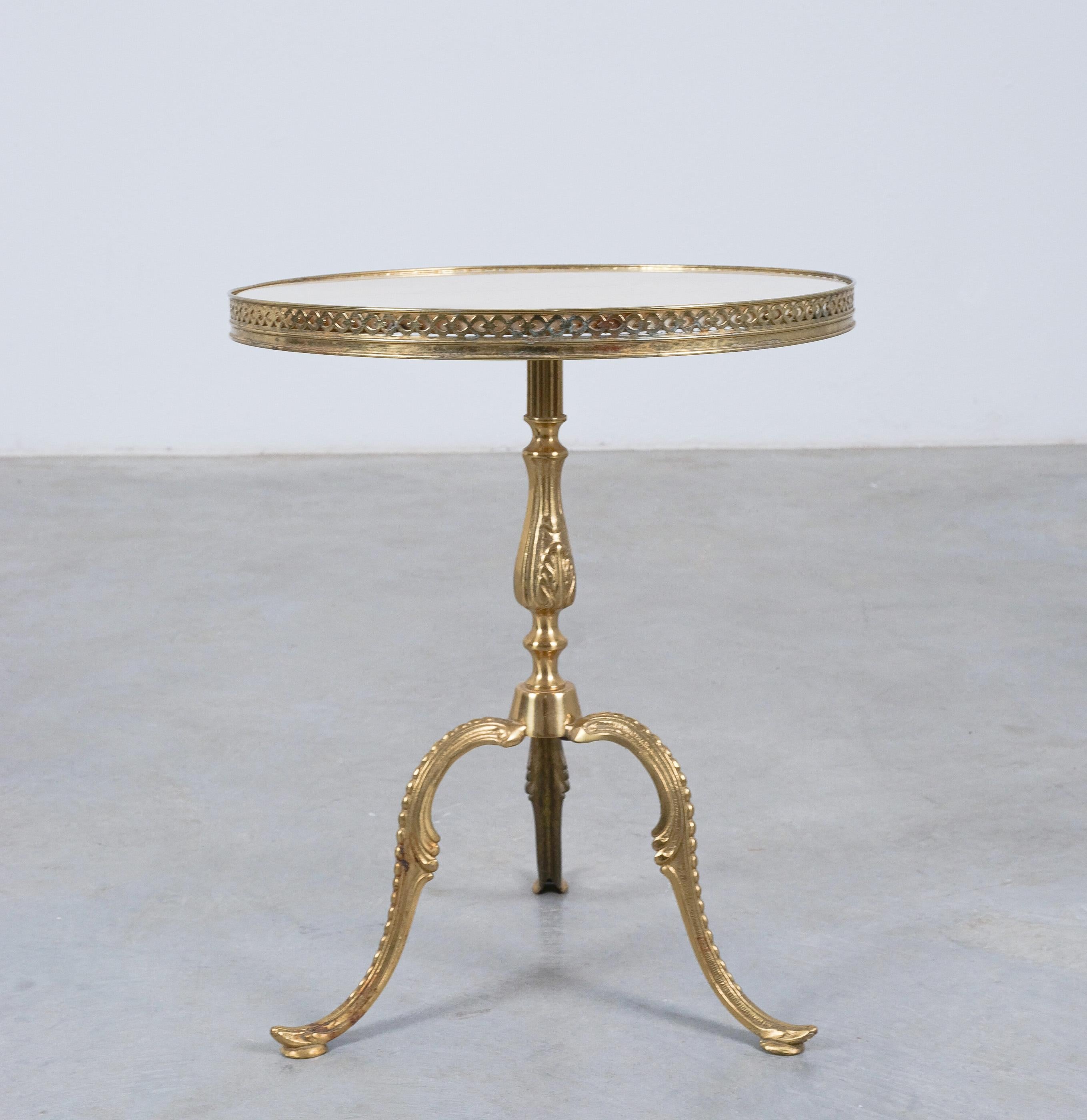 Side Table White Marble Top Brass, France, circa 1940

Side table in original vintage mid century condition. The neoclassical brass base shows some playful motives deriving more from floral art-nouveau inspiration. It's quite an eclectic piece with