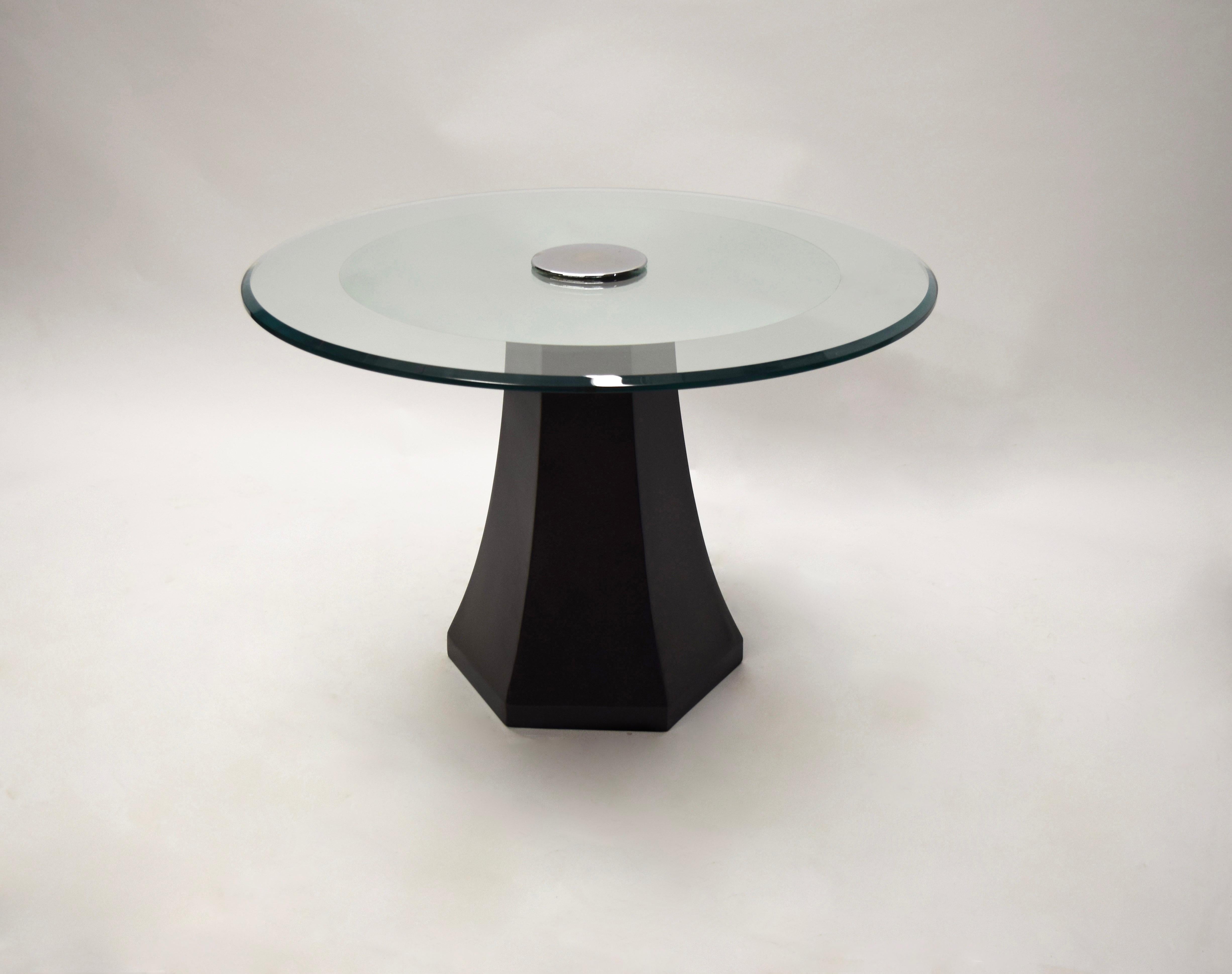 Side table with a satin black lacquered wood, hexagonal base that supports a round, beveled glass top that has a center mirrored accent; the base and top secured together by a round polished chrome-plated brass hardware piece.