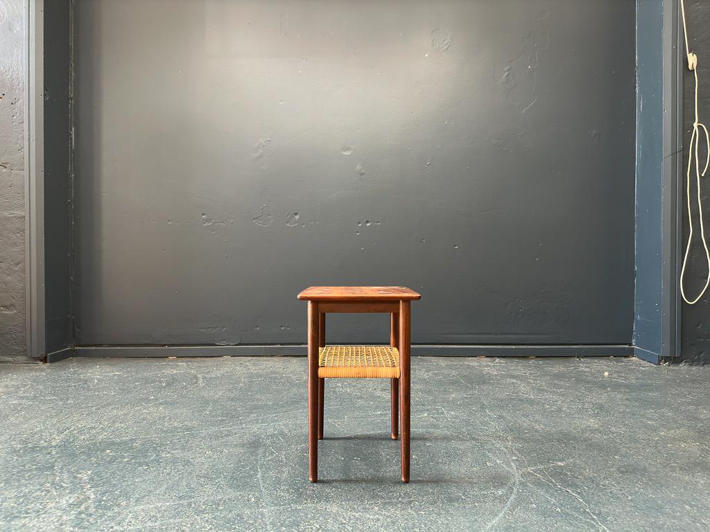 This elegant hardwood side table is unique in size with its very compact shape, the square nature of the piece enables its functional and versatile use. The thin tapered legs complement the sleek design and the beautifully hand-caned single woven