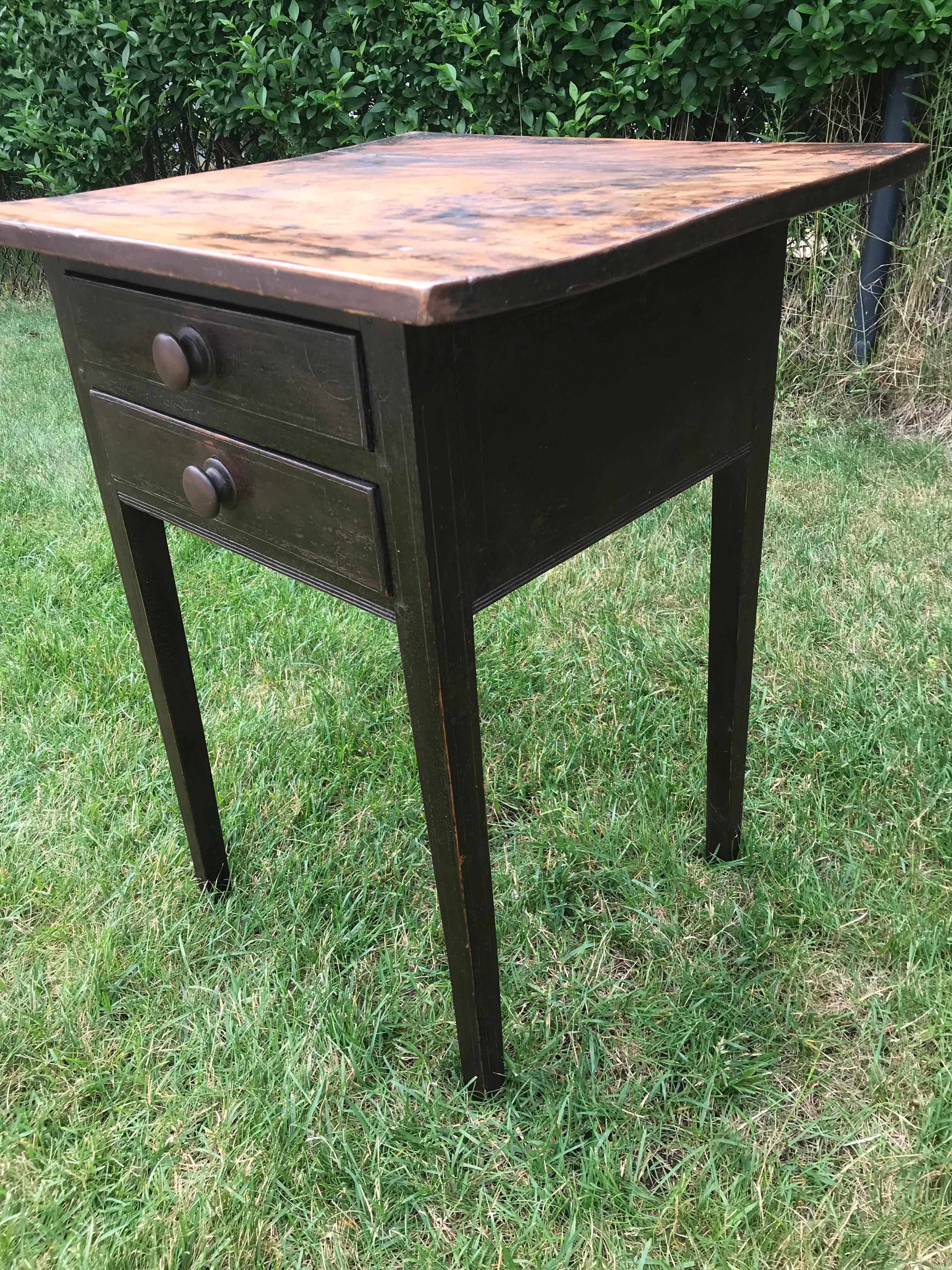 Side table with dark painted base and knobs.