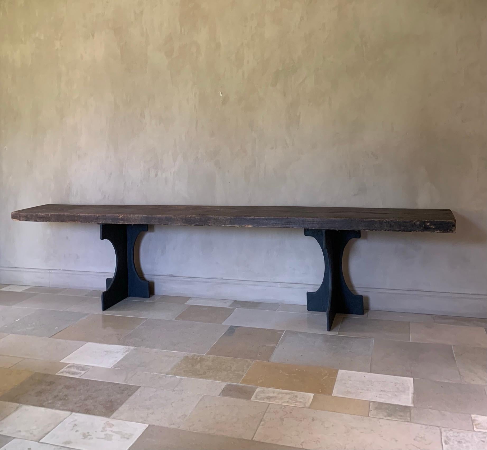 This console table was made by our workshop from a 19th century Asian Elm top and custom trestles. The top was most likely a countertop and the trestles are based on a French 19th century design.
  