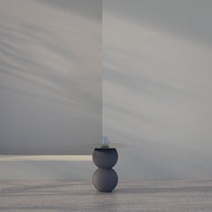 Side table with stainless steel and volcanic stone