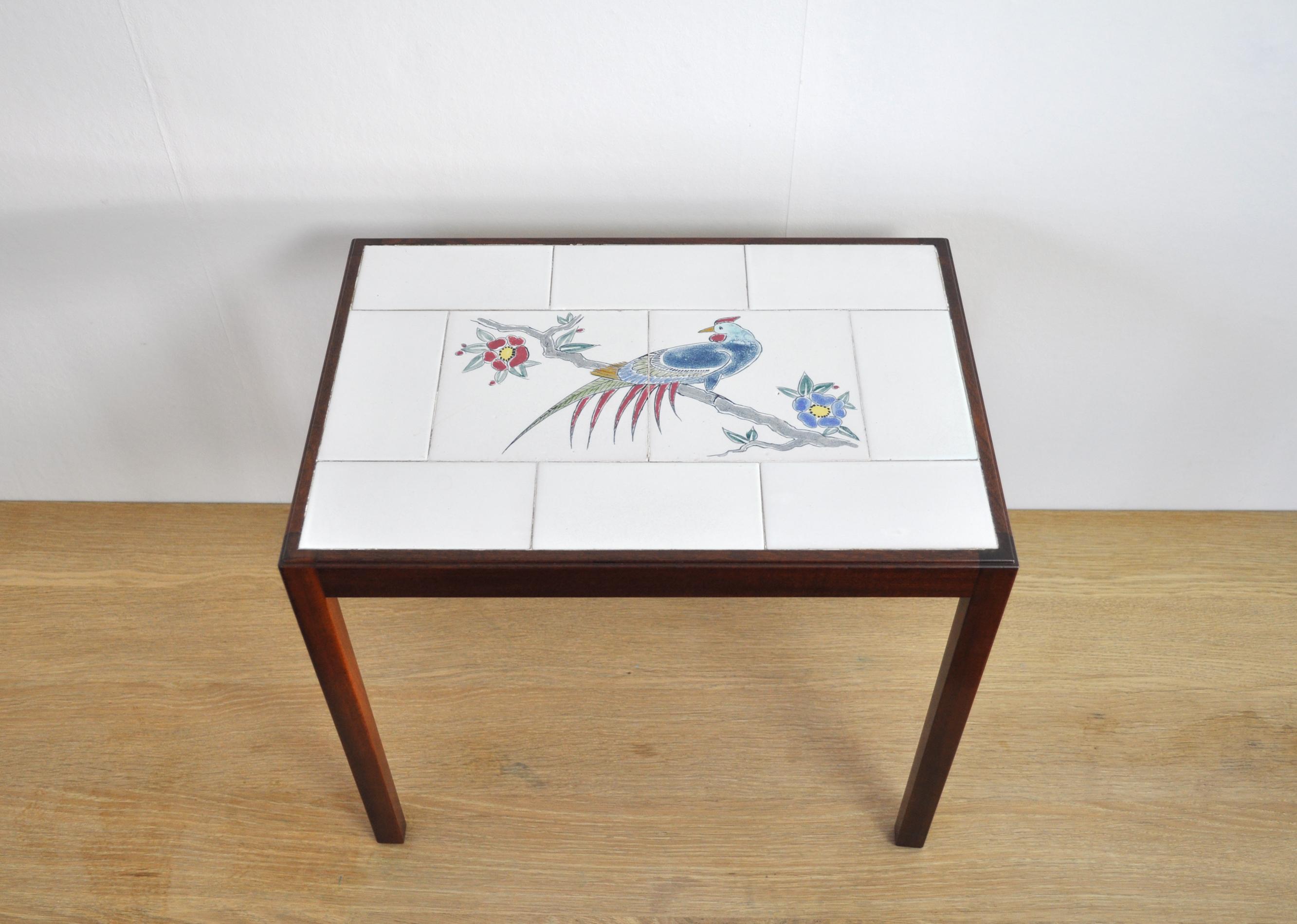 Beautiful Danish mahogany side table with tiles.
Designed and made by Master cabinetmaker Jacob Kjær.
Tiles attributed Jens Thirslund, Kähler. Thirslund known for his imaginative decorations and the glazes he developed, which for many became