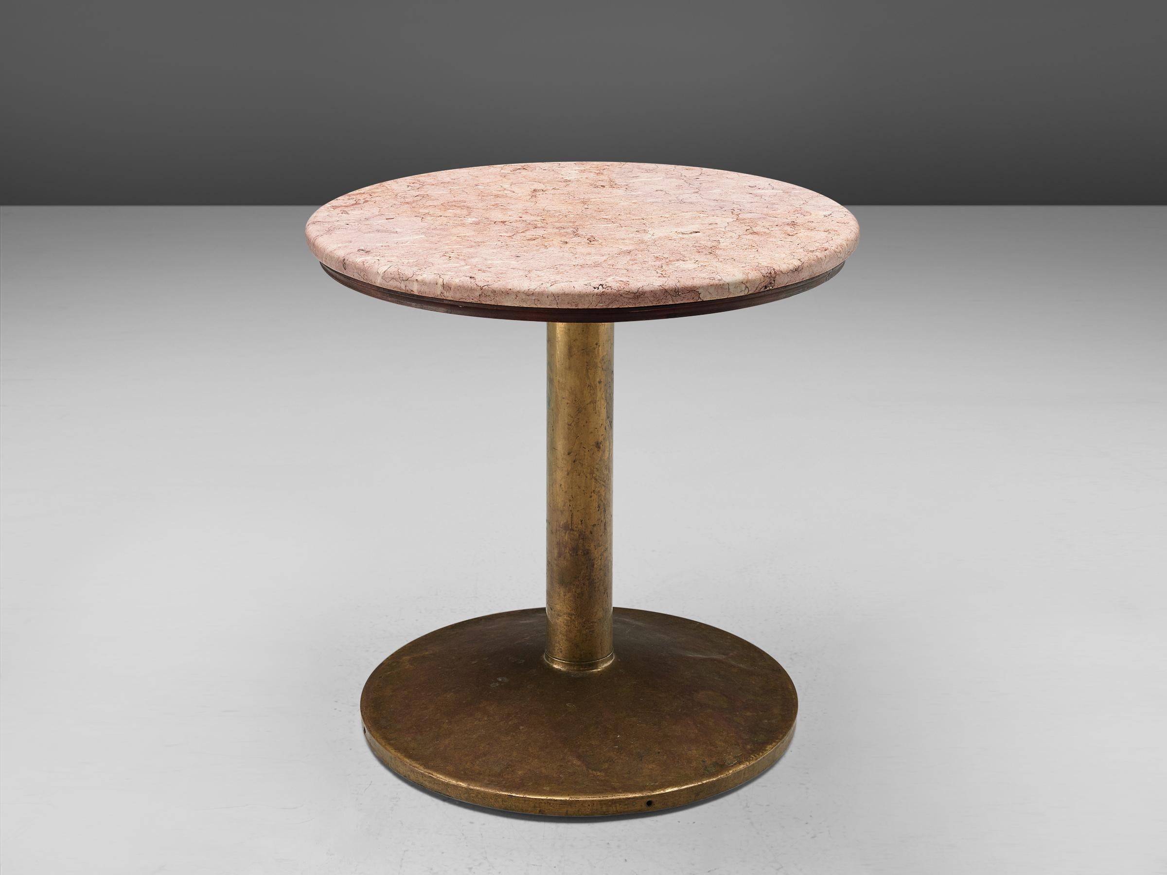 Brass side tables with rose marble top, France, 1960s.

A circular pedestal table in rose marble with a brass foot. The table has a beautiful contrast between the rustic brass base and the refined marble top. The tables are versatile in use, since