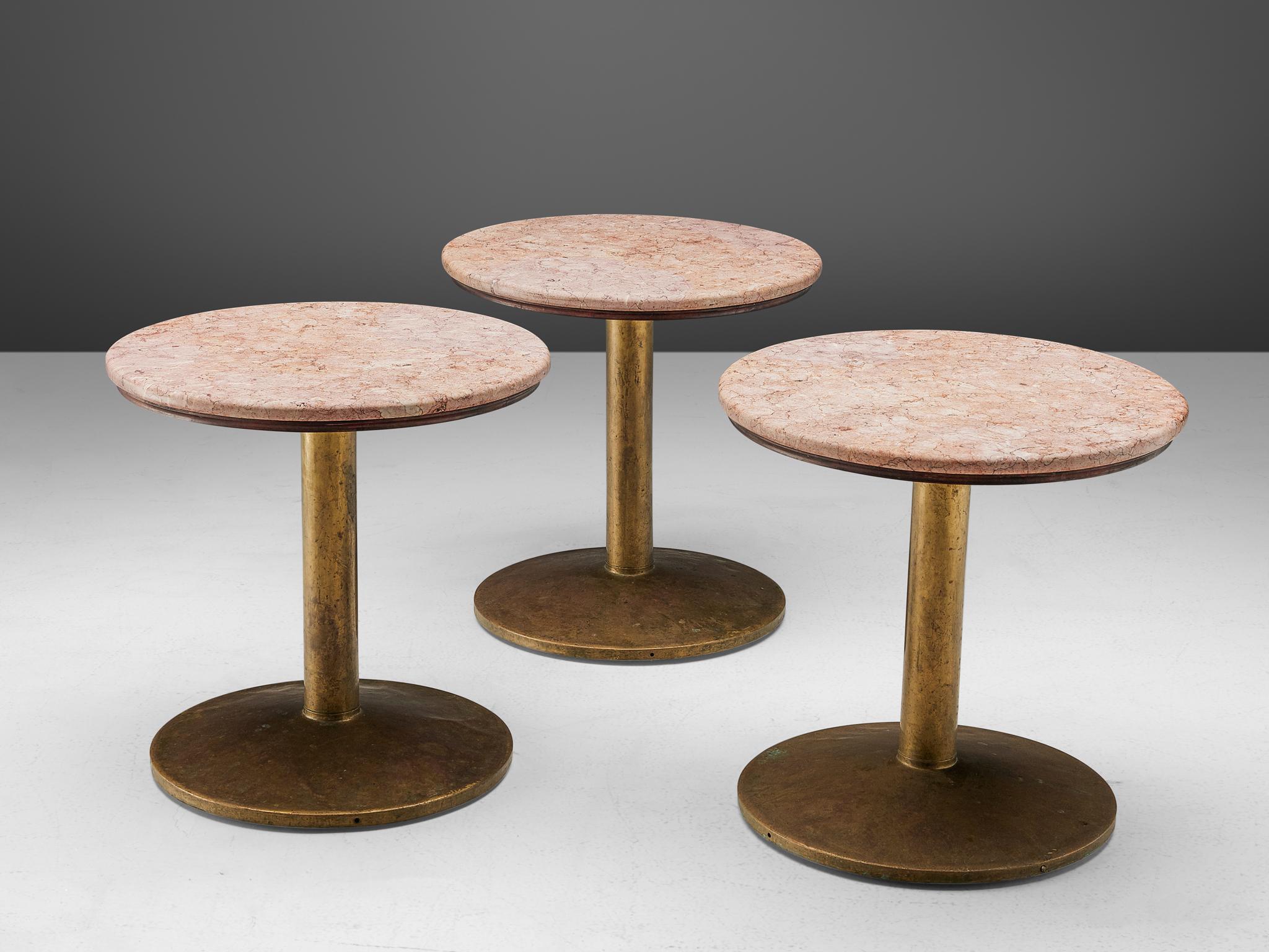 Brass dining tables with rose marble top, France, 1960s.

A circular pedestal table in rose marble with a brass foot. The table has a beautiful contrast between the rustic brass base and the refined marble top. With their modest size, these tables