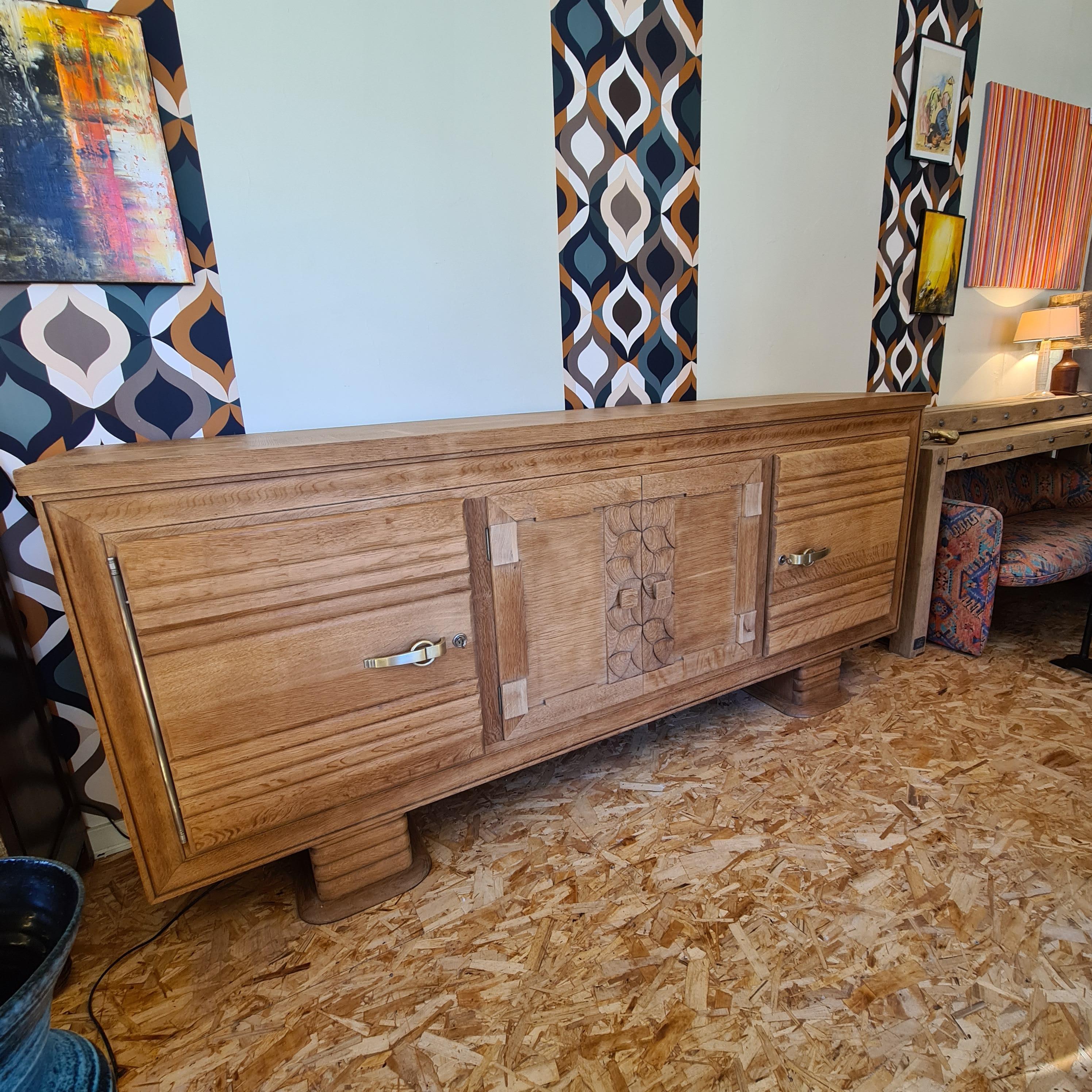 Exceptional 4-door sideboard in solid oak circa 30-40 in the style of Charles Dudouyt's work. Creation of the Marcel Schirtz Paris workshops, Mixture of rustic and modernism, this sideboard will go very well with contemporary furniture The central