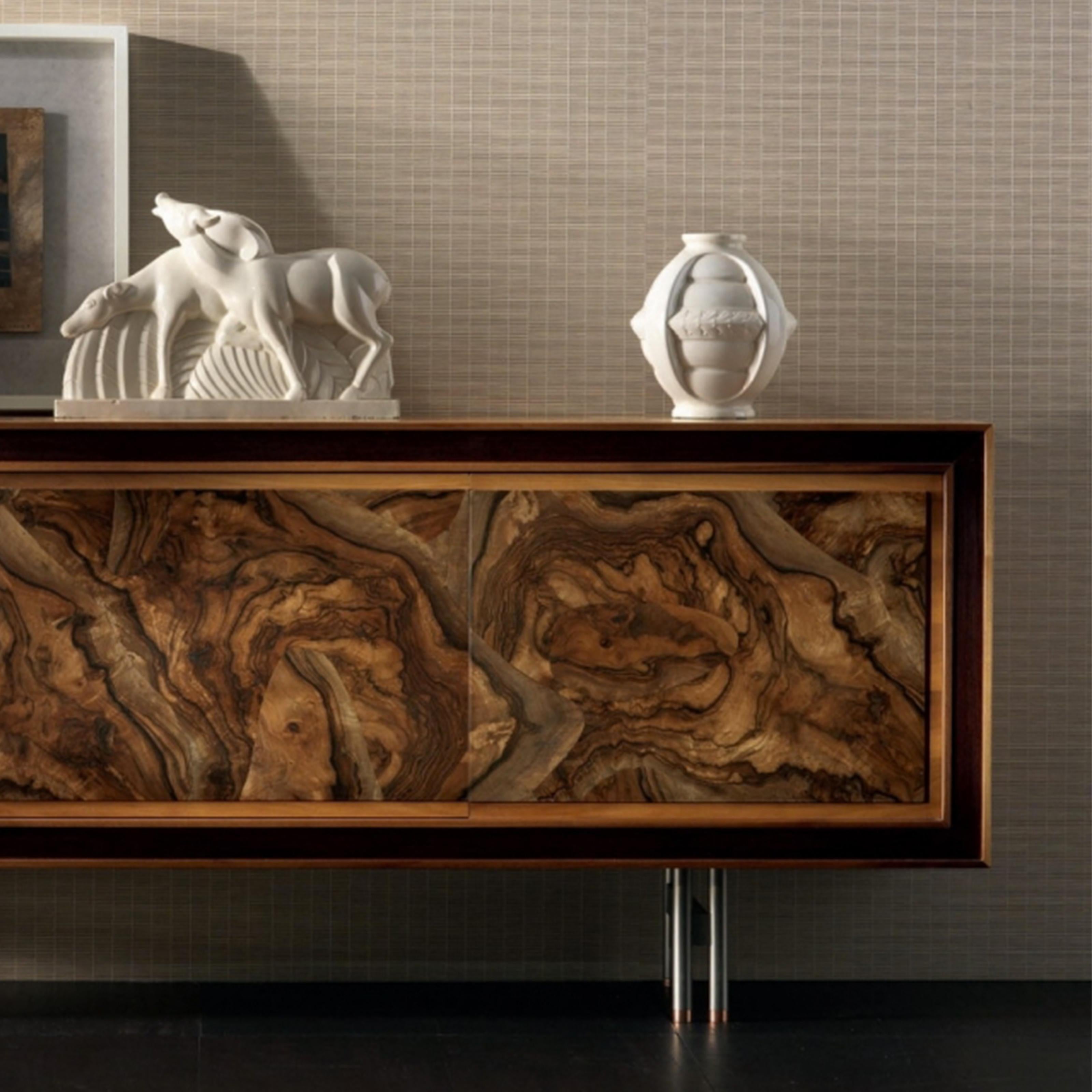 An elegant, stunning sideboard finely crafted in Italy with passion by expert hands. It's composed of three doors in premium solid walnut with fine root veneer, each piece is unique, presenting different wood veins. The oil finish brings out the