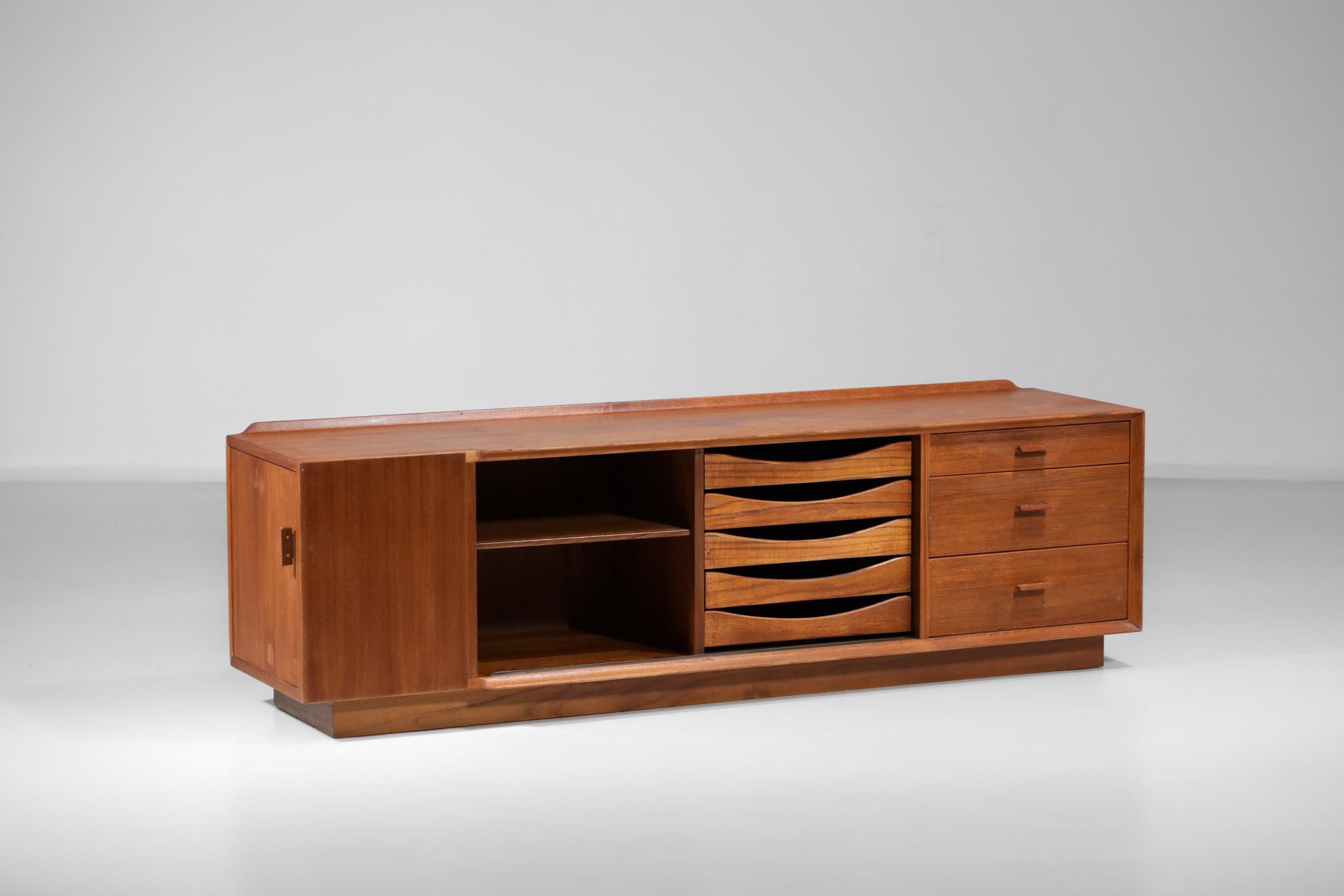 Sideboard from the 60's by designer Arne Vodder published by Sibast. Structure in solid teak and veneer. The front consists of five drawers, a sliding door opening from the adjustable shelves, three drawers of different sizes in solid teak and on