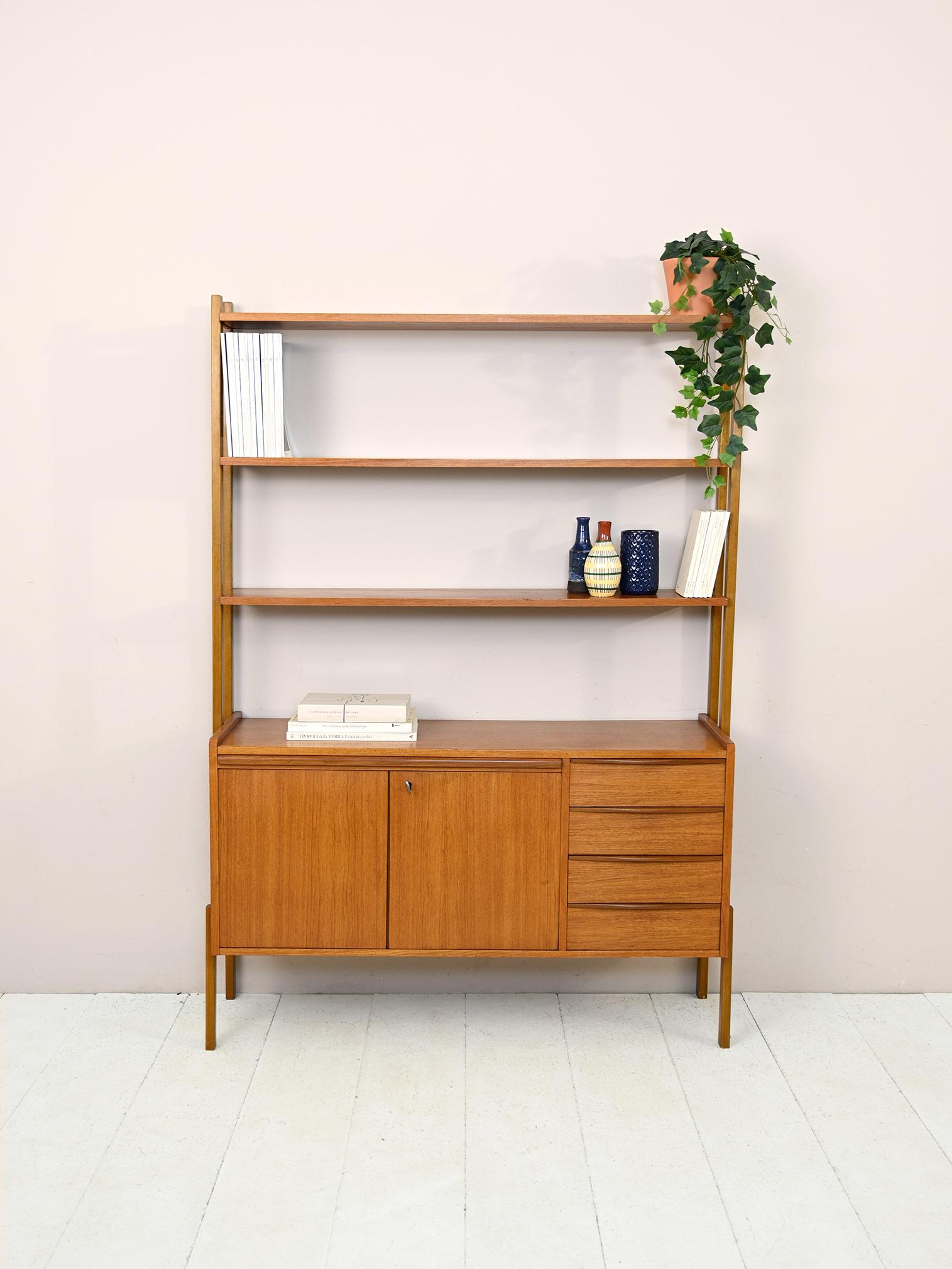 Vintage sideboard.

Swedish modern antique teak bookcase cabinet. 
The lower part is a small sideboard equipped with 4 drawers and a storage compartment with sliding doors and lock. The pull-out top allows it to be transformed into a small desk