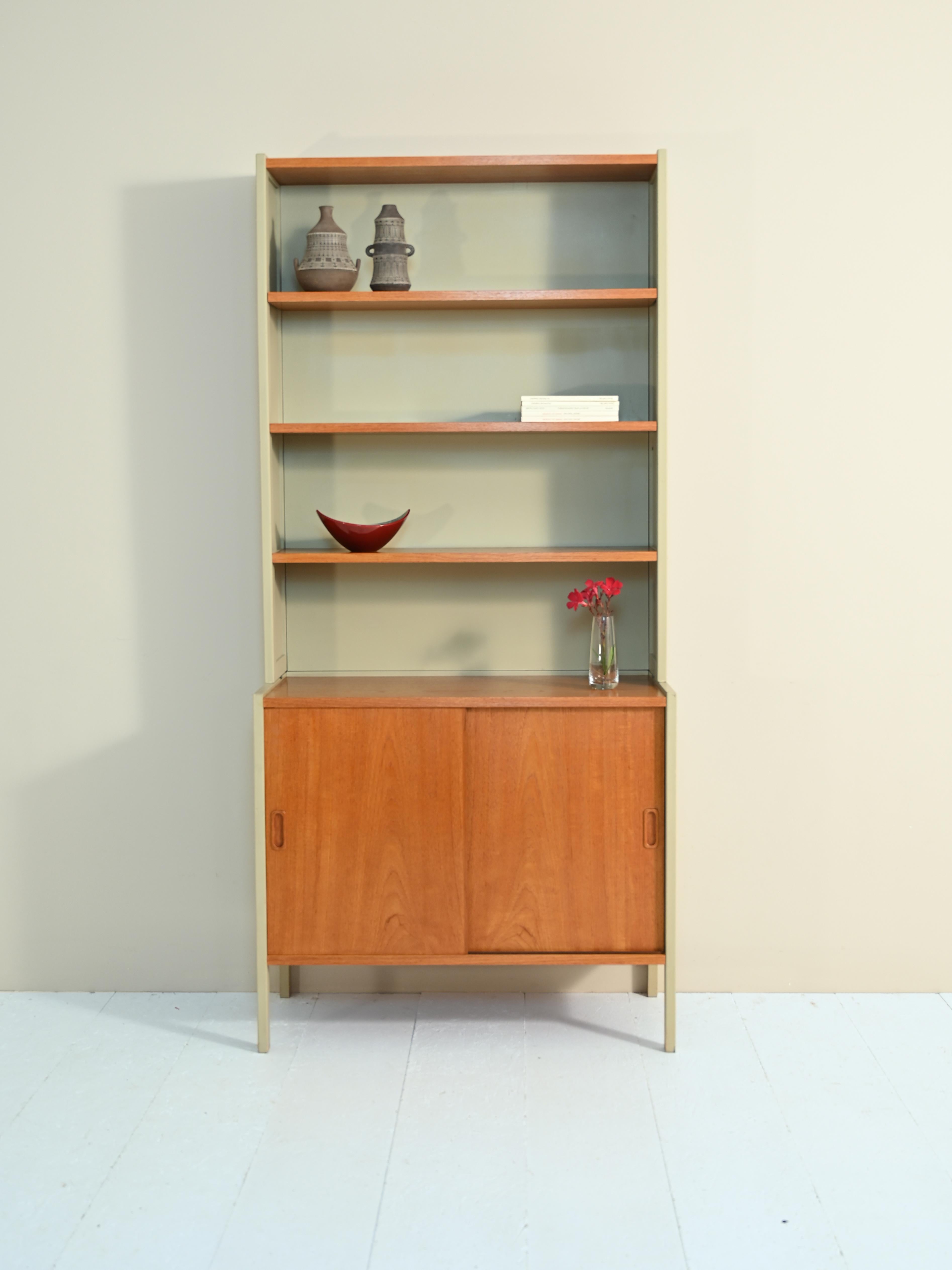 Bookcase with shelving and sideboard, original vintage 1960s.

Original vintage cabinet of Scandinavian origin, consisting of two parts. 
The upper part is a bookcase equipped with adjustable height shelving, the lower part is a cabinet equipped