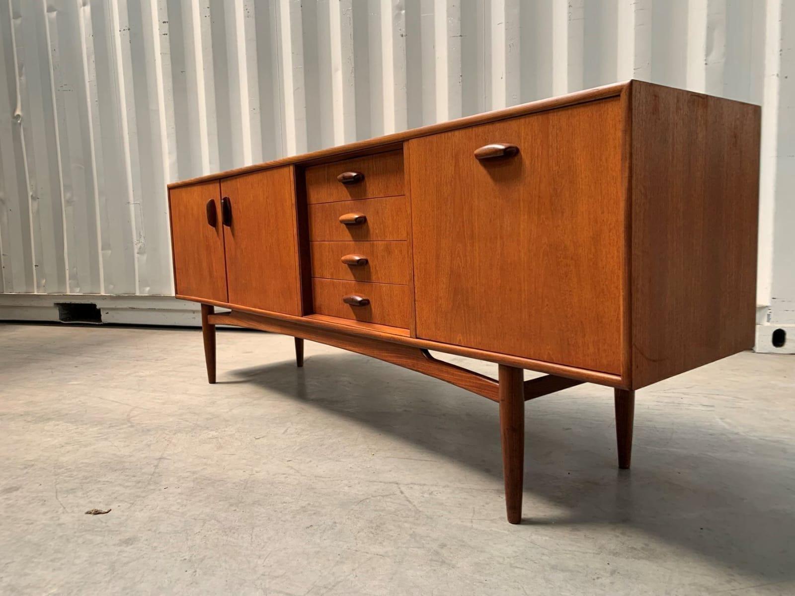 Sideboard “Brasilia”, Victor Wilkins for G Plan, UK, 1960

Additional information:
Country of Manufacture – UK
Design Period – 1960
Production Period – 1960
Style – Midcentury / Nordic Design
Material – Teak Wood
Color – Brown
Dimensions – H. 78 X