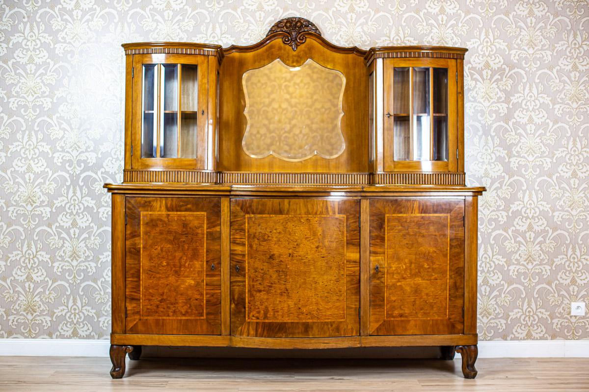 Sideboard or Buffet from the Interwar Period Veneered with Walnut

We present you this piece of furniture veneered with mahogany.
The door leaves have some burl elements.
The sideboard/buffet is composed of a three-leaf base and an add-on unit with