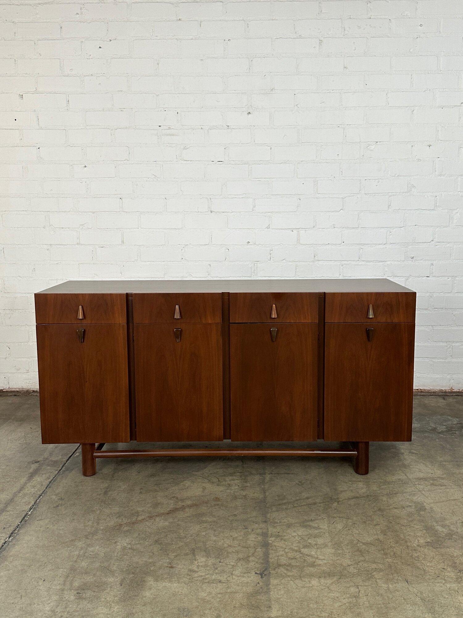 W61.75 D19.5 H32

Rare Walnut sideboard in fully restored condition. Item is structurally sound, fully functional, and offers a nice dark deep walnut finish. Item has original manufacture stamp and offers both open and closed storage.

We offer full