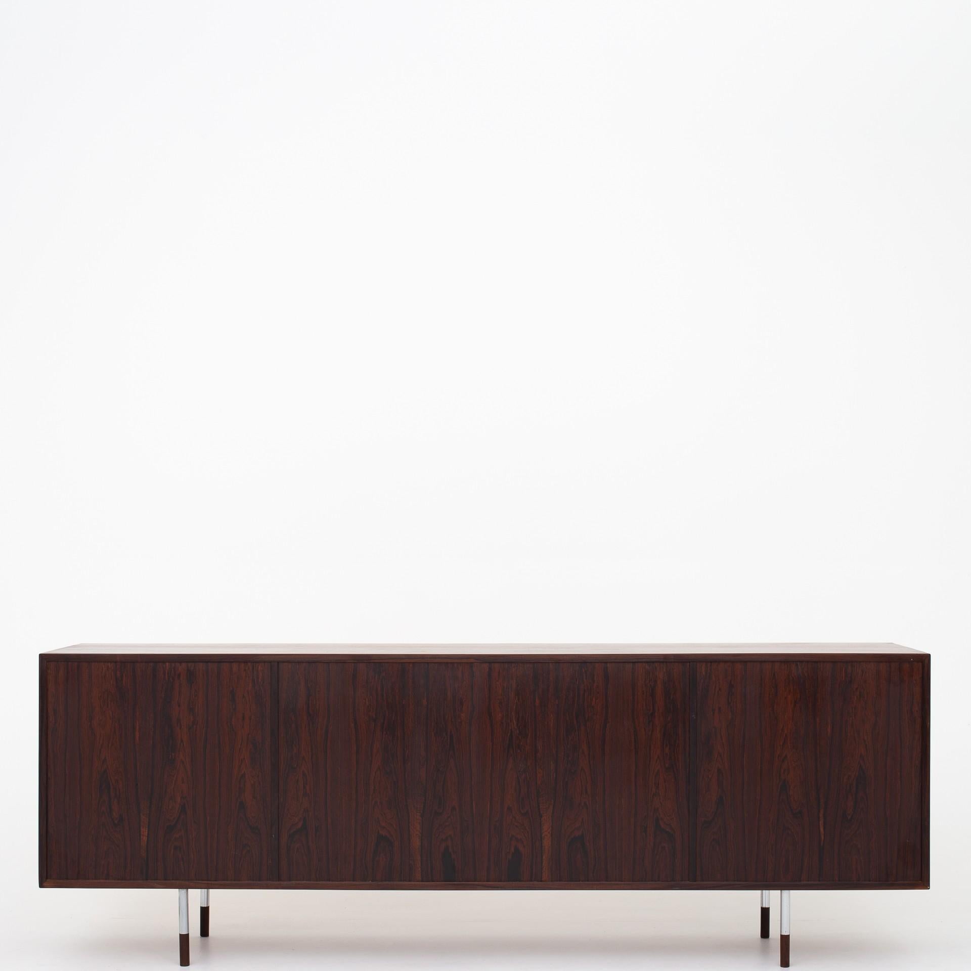 Sideboard in rosewood with tambour doors. Freestanding. Metal legs and rosewood feet. Maker Sibast furniture.