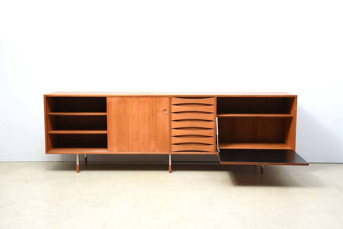 Sideboard by Arne Vodder for Sibast Denmark 1960 rare production. Long teak sideboard by Arne Vodder for Sibast Denmark with beautiful finishing details. Left side 2 sliding doors (can be turned to black back), right side hinged door, in the middle