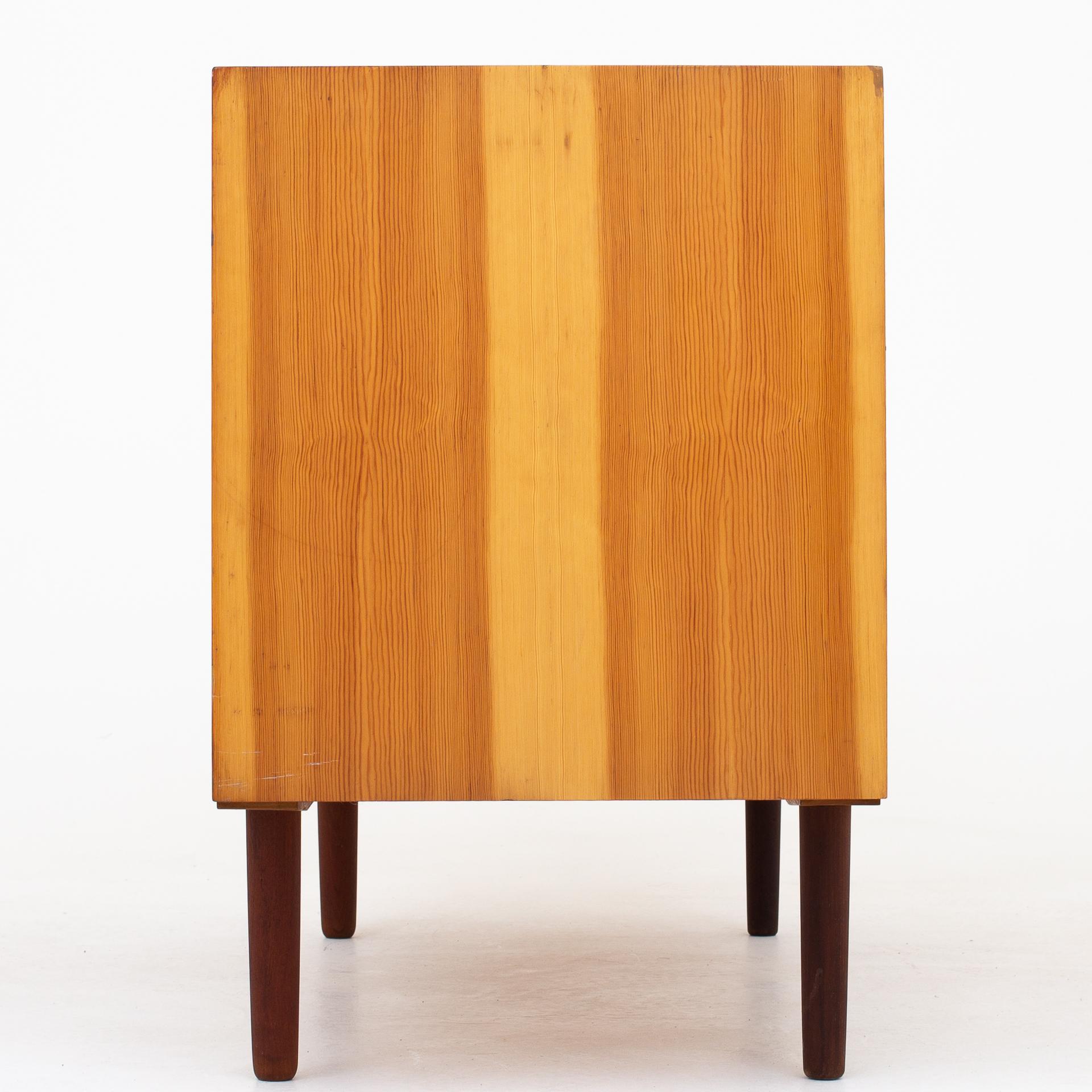 Sideboard in pine and teak with two sliding doors. More pieces in stock. Maker Svensk Fur.