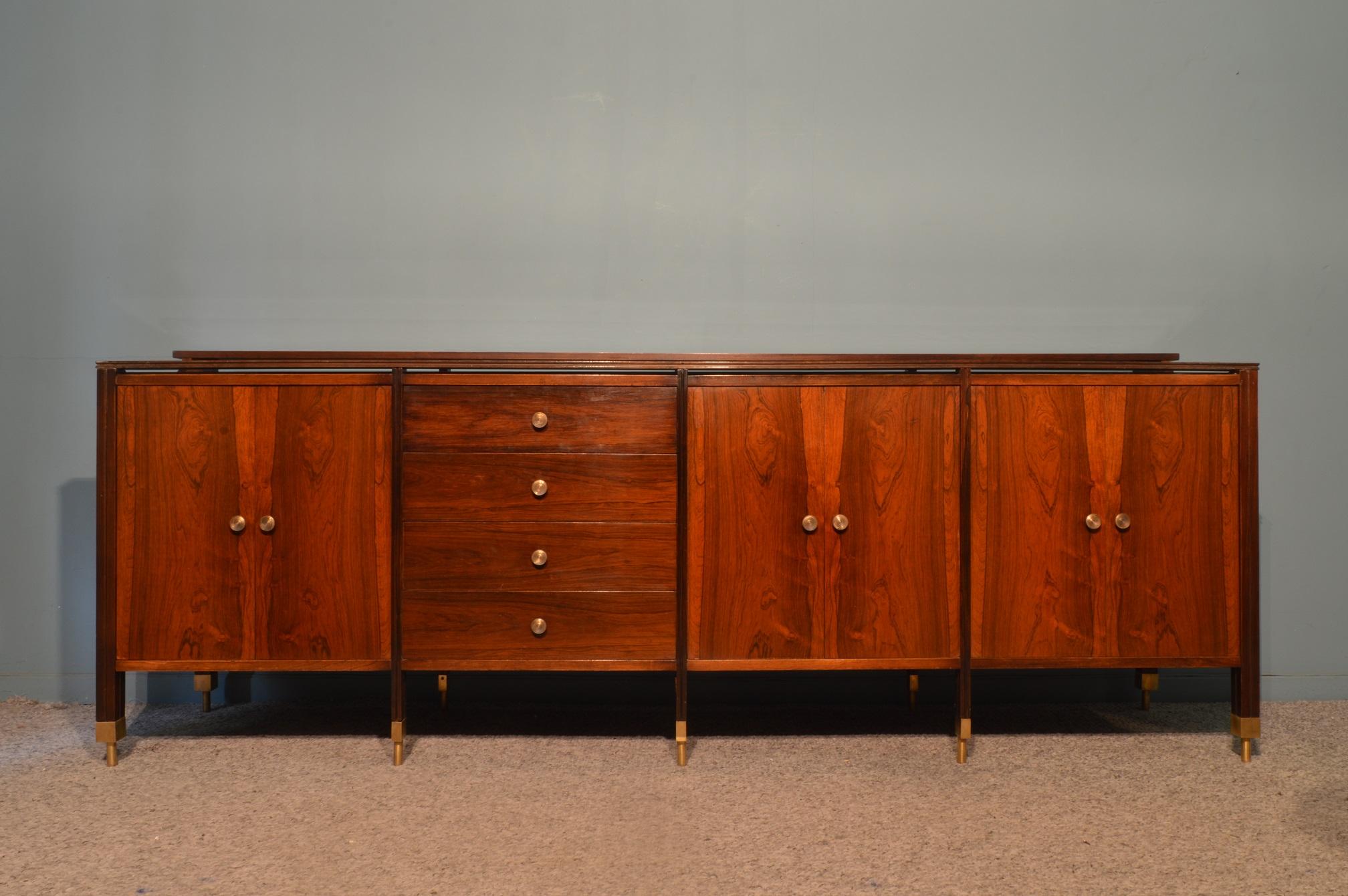 Sideboard bi Carlo di Carli in rosewood, opaline glass and brass.
Italian work, circa 1960.
The top is covered by a black opaline glass.
Each parts are in rosewood even back and inside.
Each feet and handles are in solid brass.
This furniture