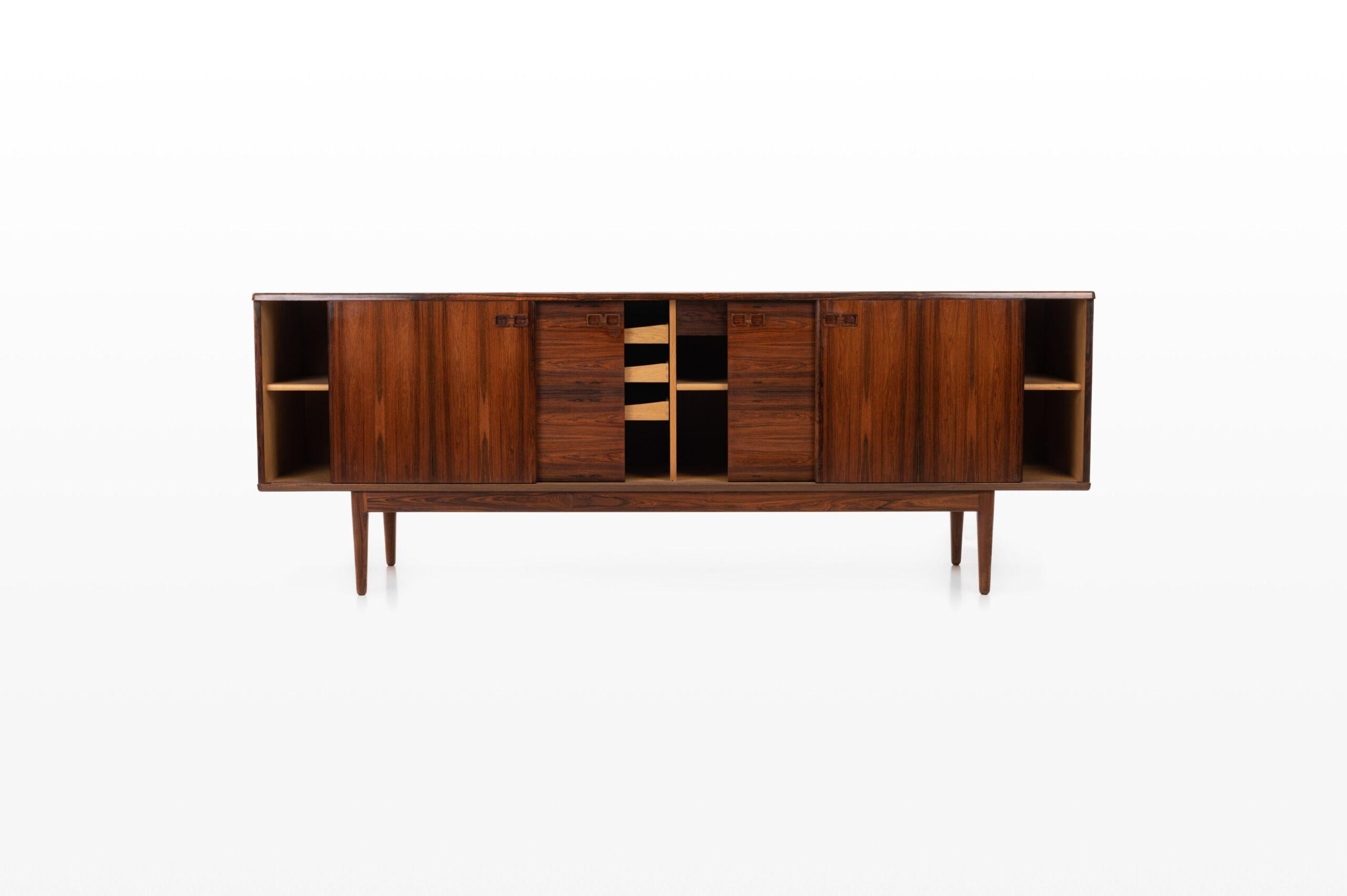 Beautiful sideboard designed and produced by Christian Linneberg for Christian Linnebergs Møbelfabrik. The sideboard is finished in rosewood and on the inside in oak, very high quality. There are four sliding doors, four inner drawers and plenty of