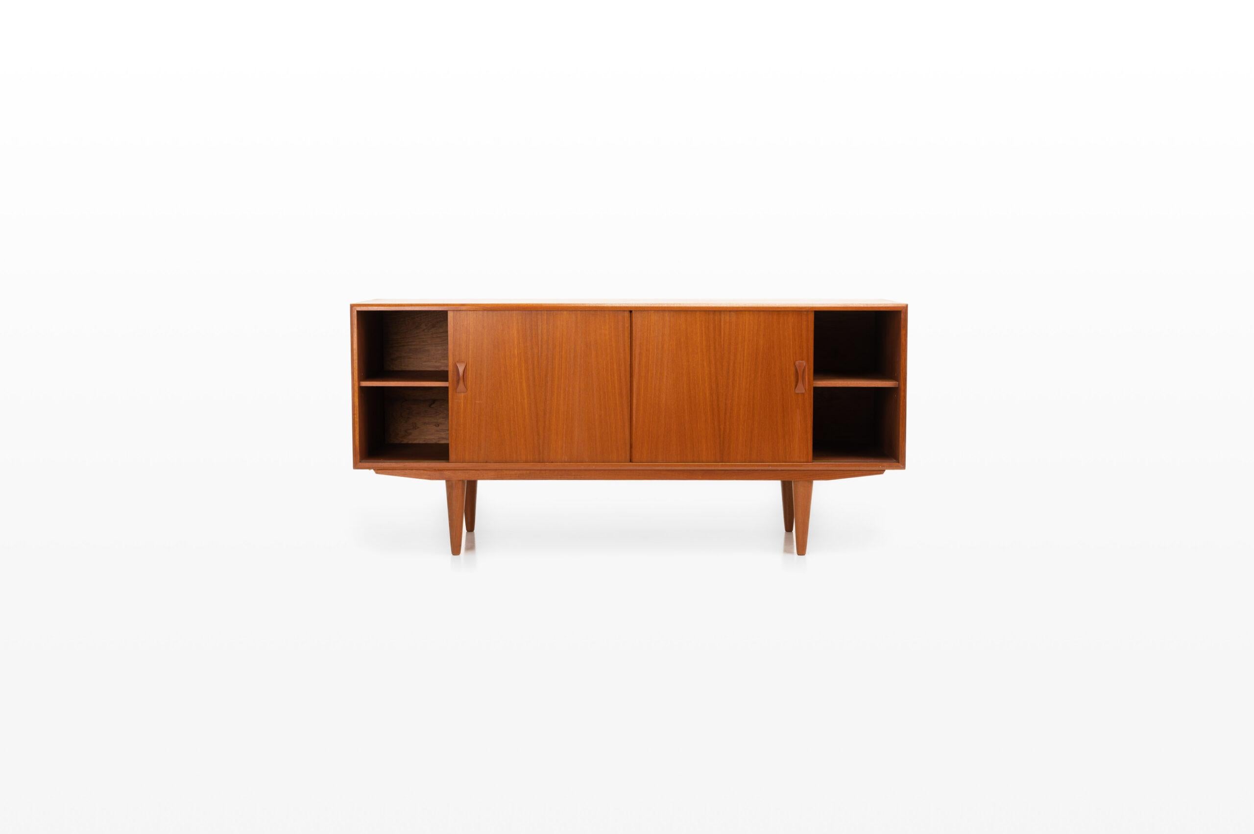 Beautiful vintage teak sideboard produced by Clausen & Son, Denmark. The sideboard has two sliding doors and four drawers.
 