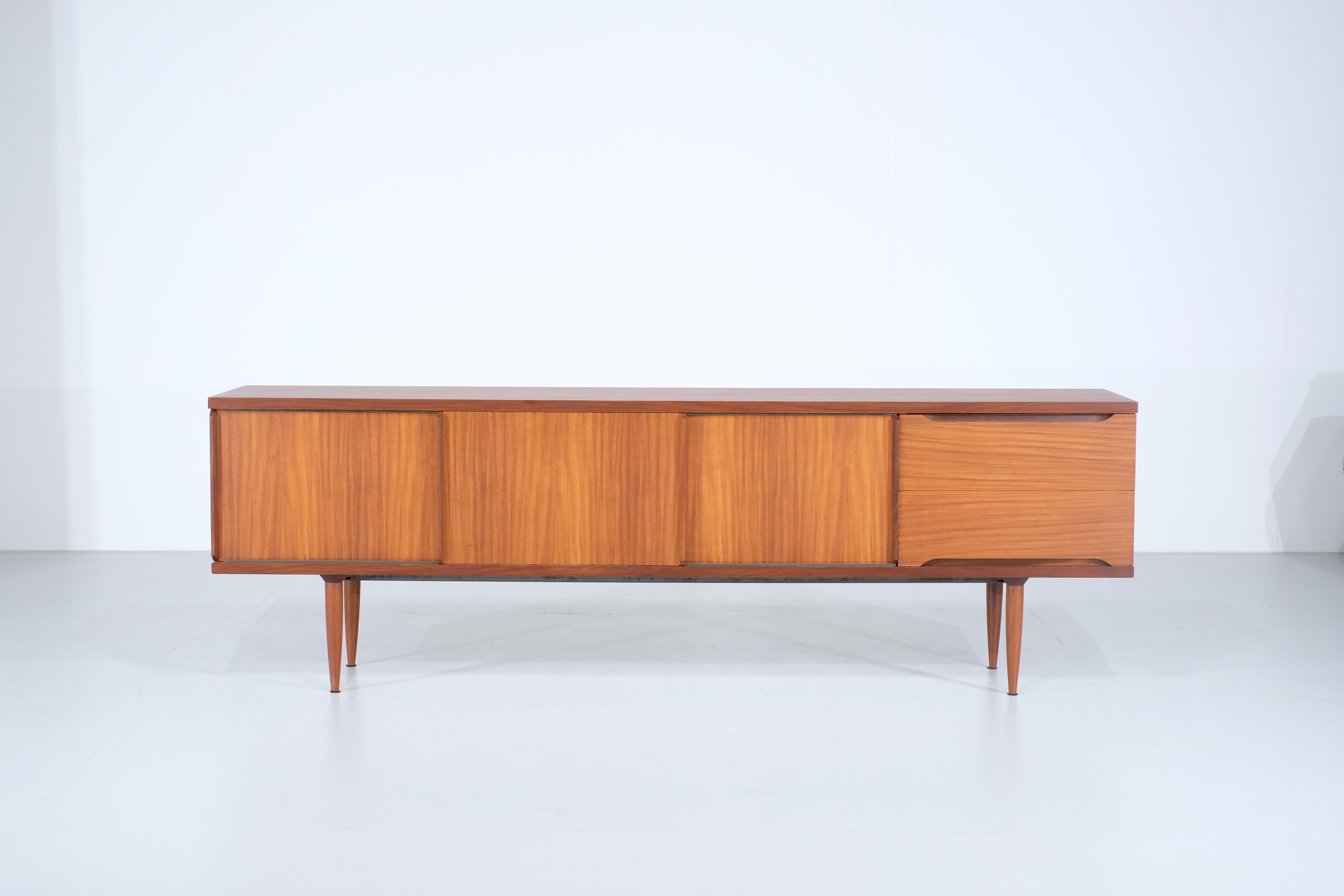 Superb teak sideboard coming straight from Italy and produced by Dal Vera in the 1960s.

The exterior of the sideboard has been completely restored and is therefore in superb condition. The interior shows some signs of wear and use but without