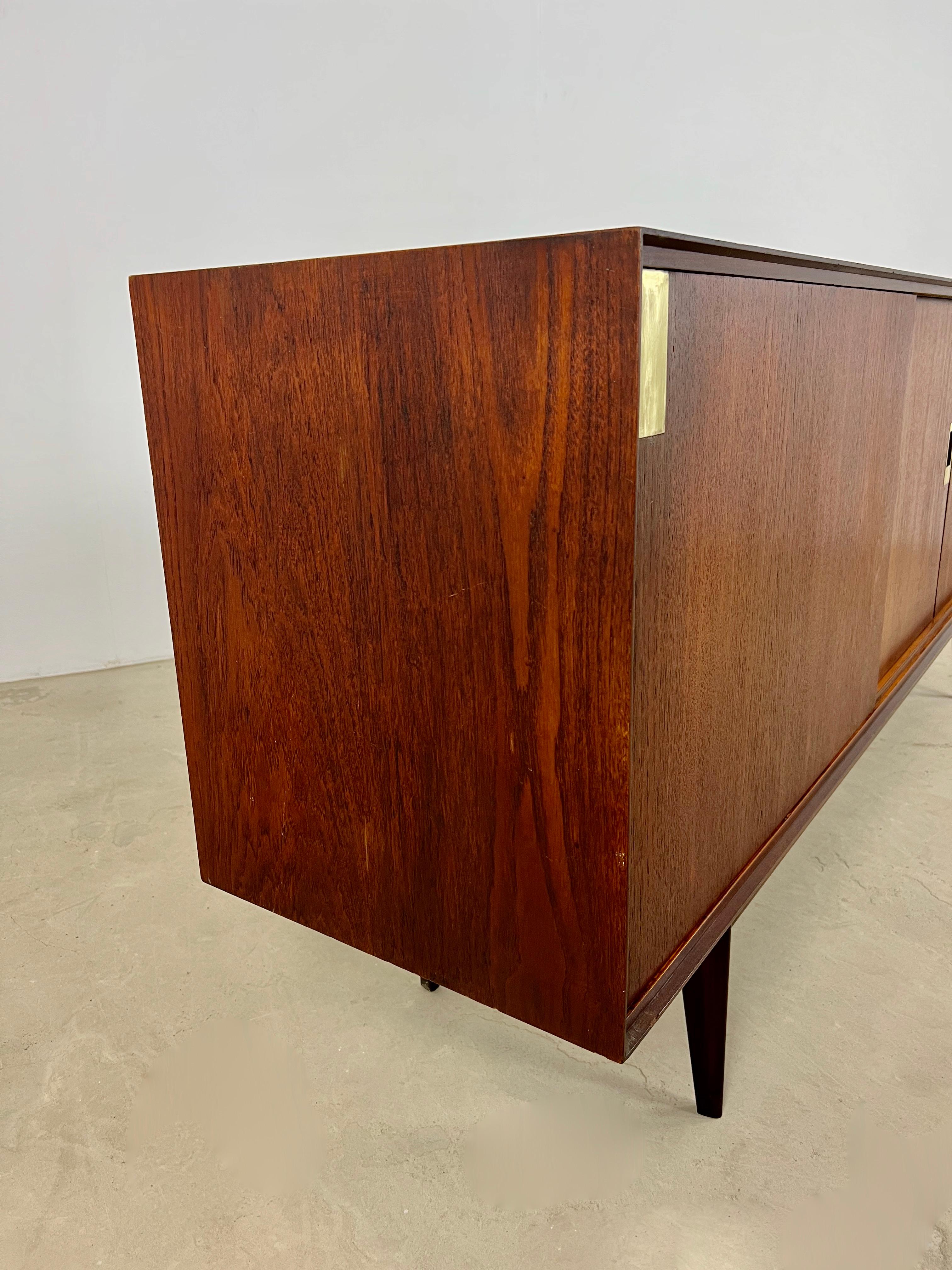 Wooden sideboard, composed of 3 doors, a sliding door, 5 drawers, a key. Wear due to time and age of the sideboard.