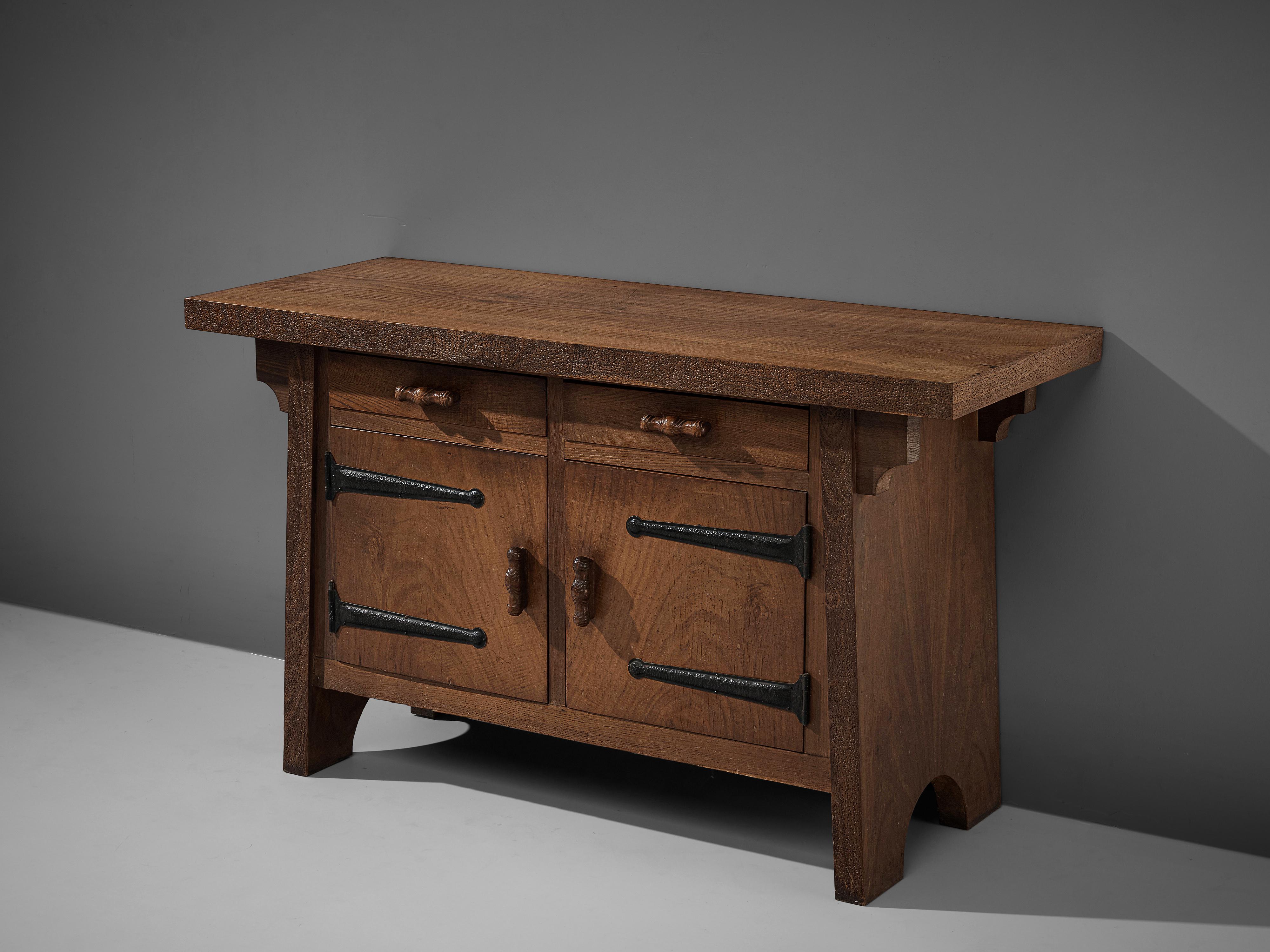 Ernesto Valabrega, large sideboard, oak, iron, Italy, circa 1935.

This sideboard by Ernesto Valabrega features not only visual qualities but also great storage space. Two drawers and two doors are structuring the outside. Decorative details are the