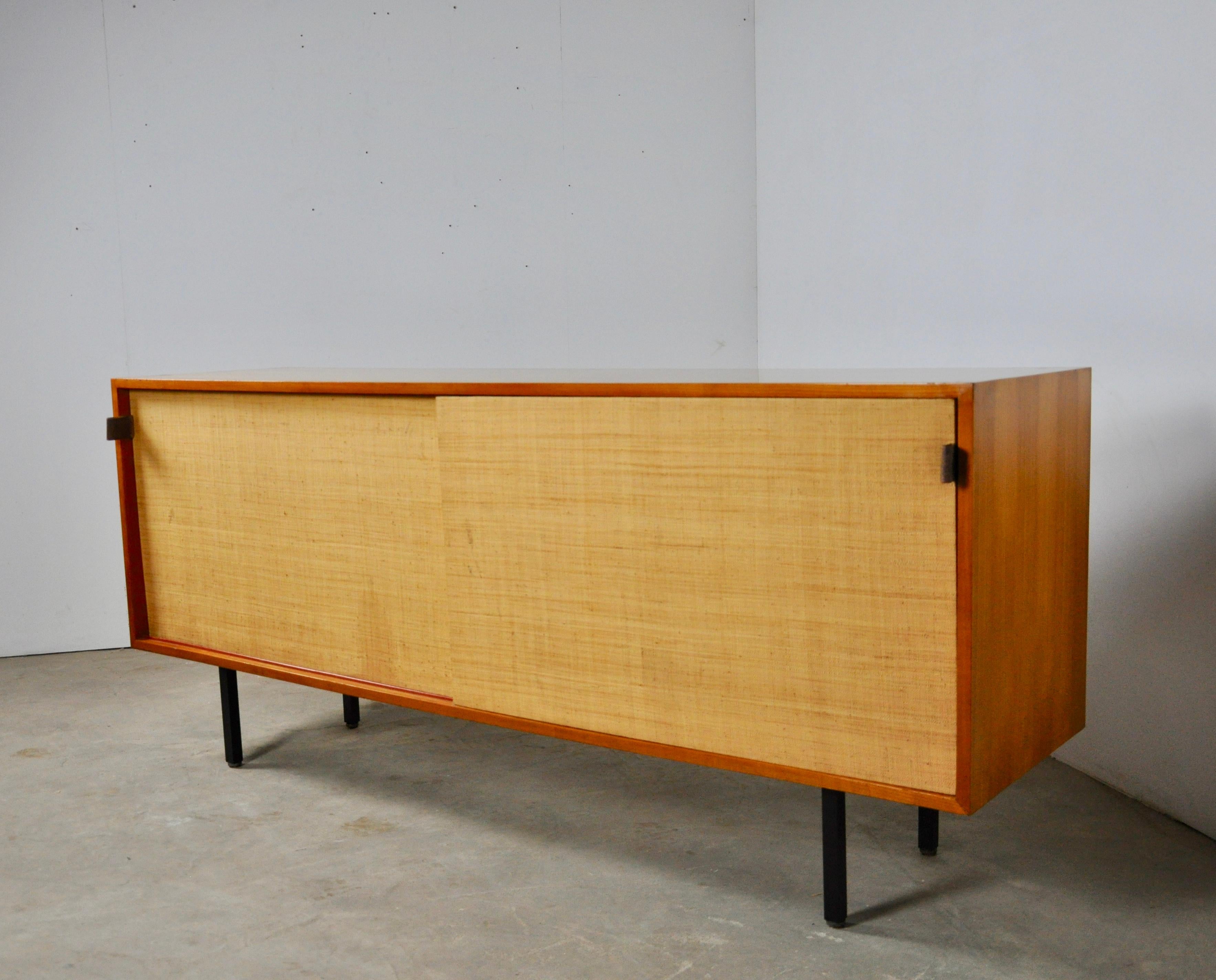 Sideboard by Florence Knoll Bassett for Knoll International, 1950s
Enfilade composed of two sliding doors with leather handles. Adjustable intermediate boards. 1 drawers covered.
Some wear marks (see photo).