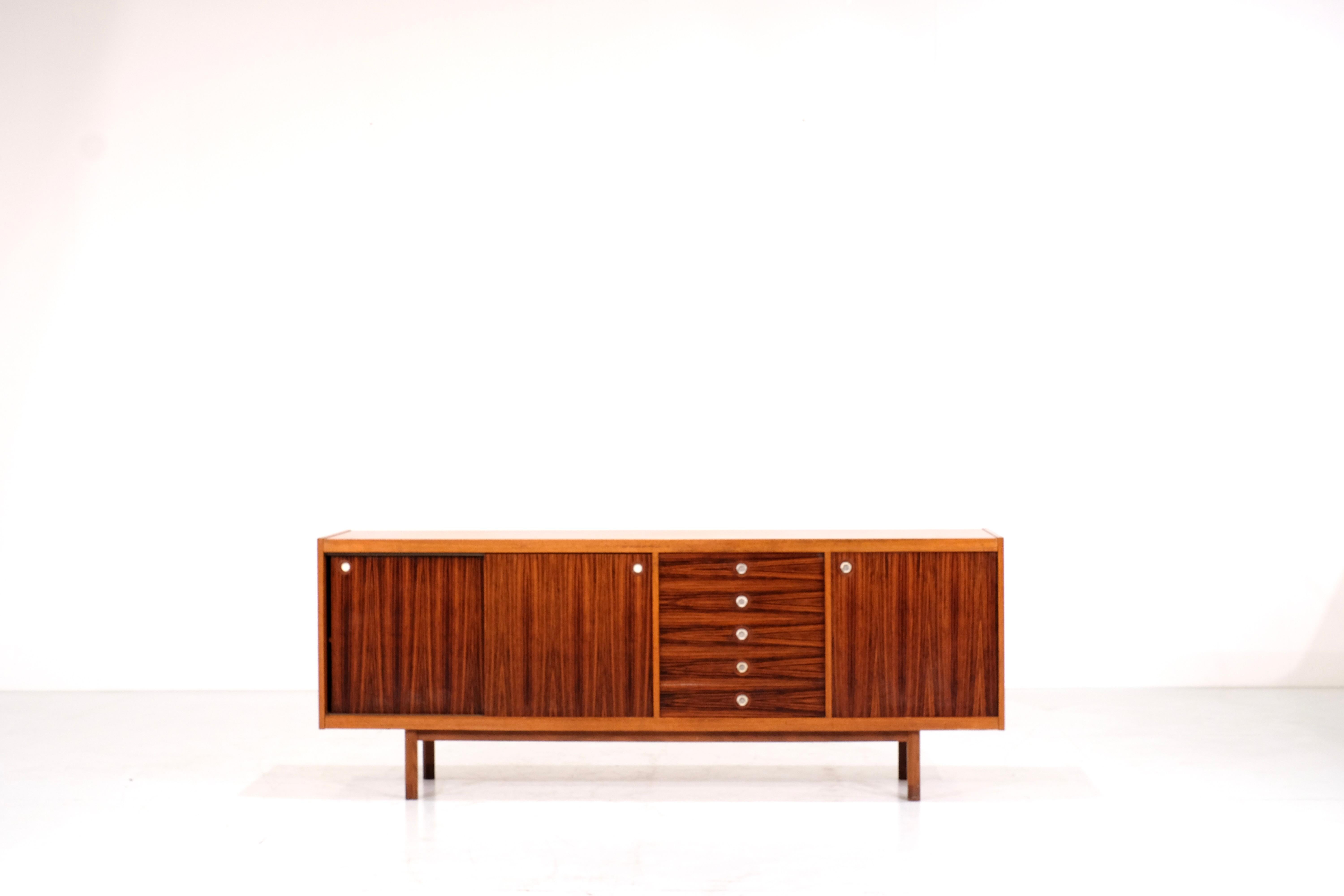 Great sideboard designed in the 1950s by Georges Coslin in Italy.

The combination of the 2 types of woods bring to this sideboard a great and original design.
the handles are made of metal and as you can see on the pictures there are a lot of a