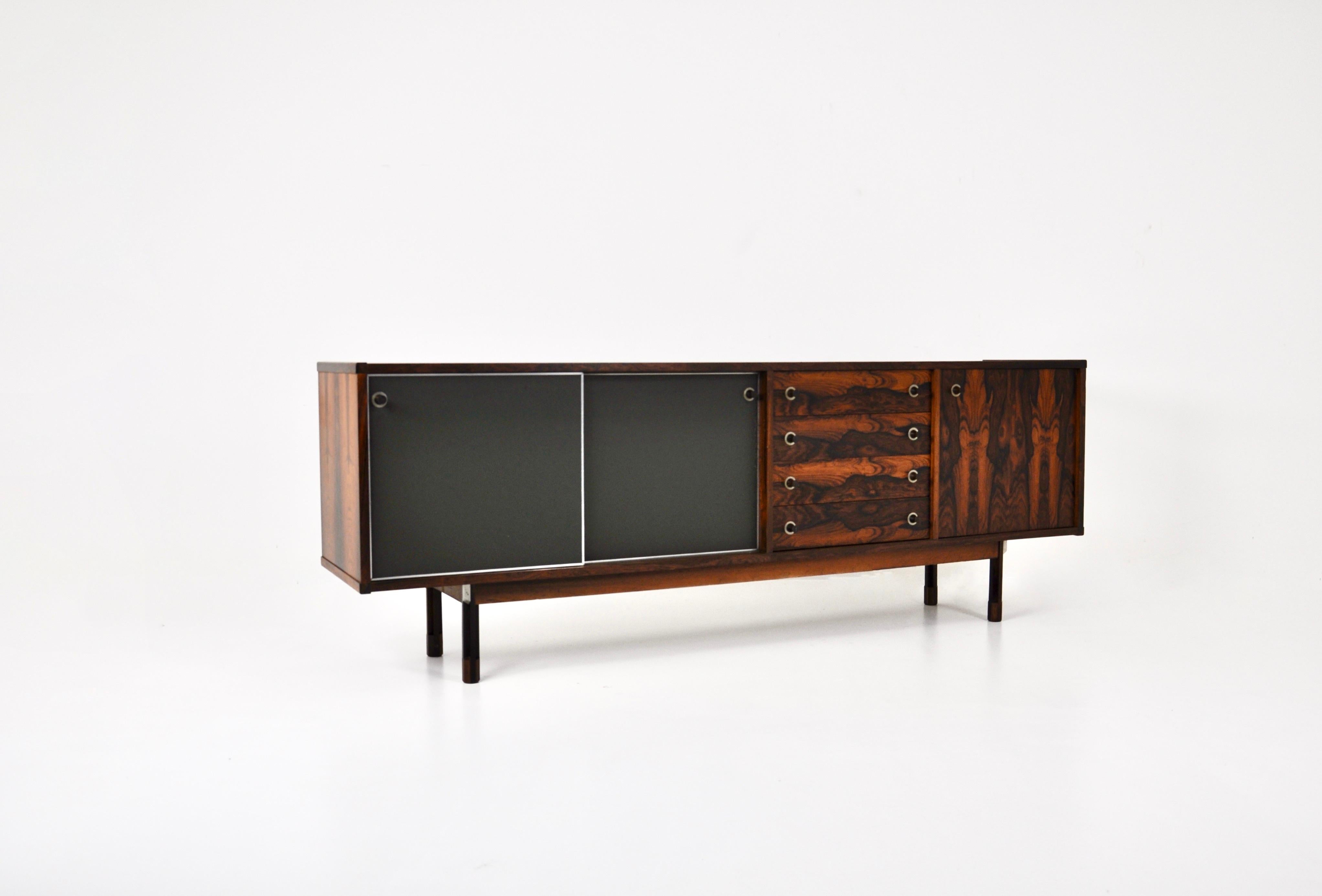 Sideboard with 2 sliding doors with skai containing a shelf, 4 drawers and a door containing a shelf. Designed by George Coslin in the 1960s. Wear  due to time and age
 
