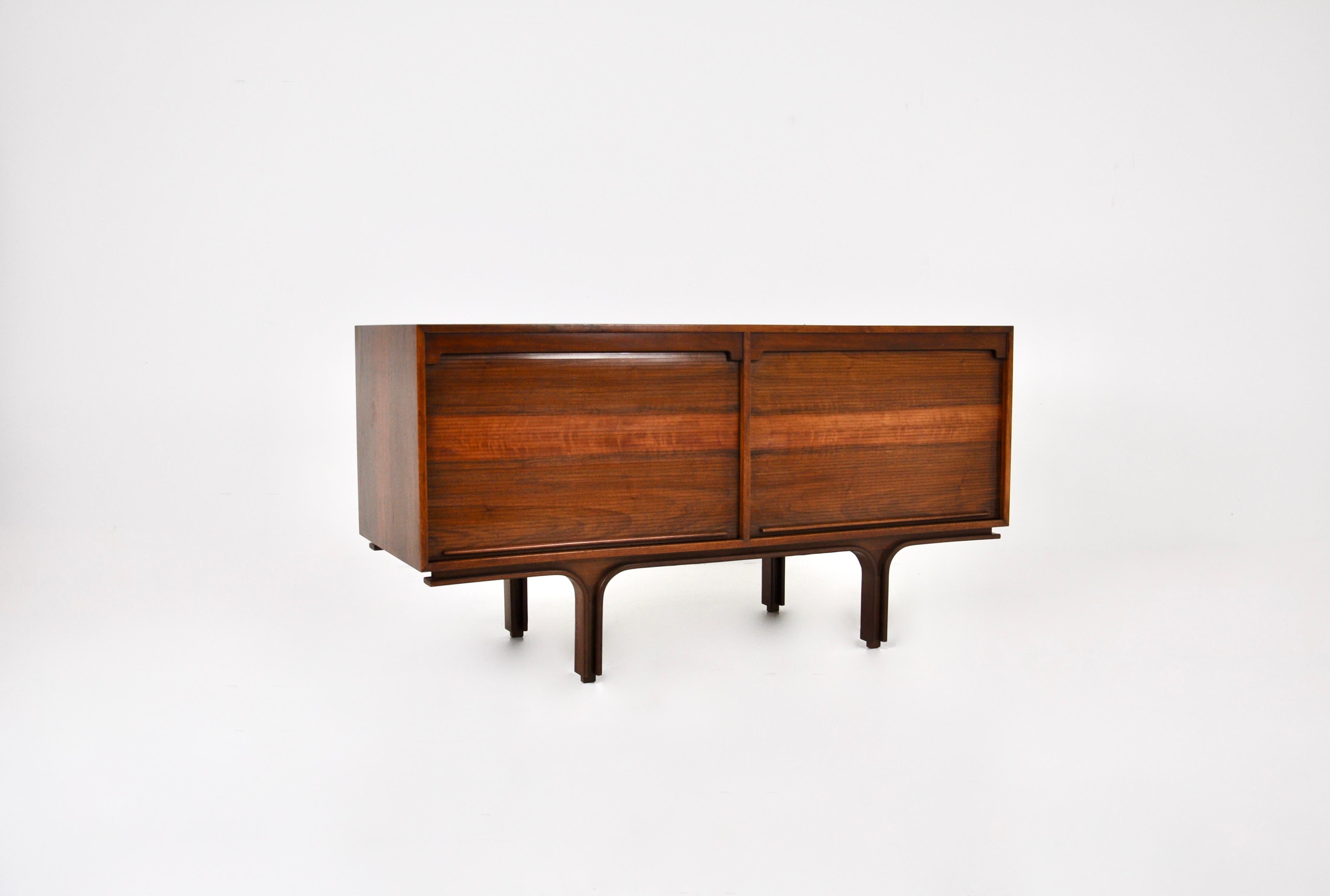 Wooden sideboard with 2 sliding doors, each compartment contains a shelf. Stamped Bernini on the inside. Wear due to time and age of the sideboard