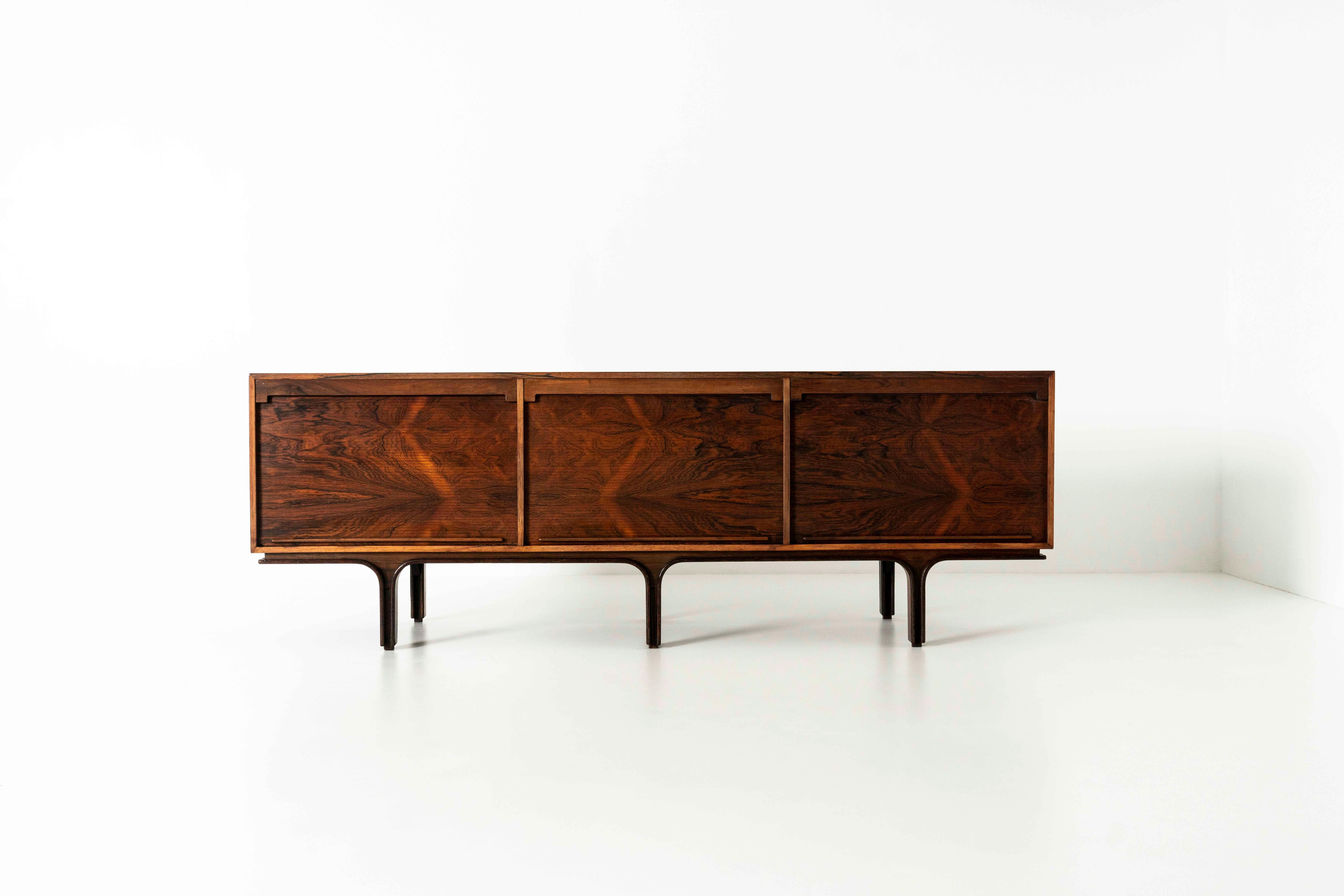 Amazing sideboard in rosewood by Gianfranco Frattini for Bernini from Italy, 1963. The sideboard has three tambour doors. Behind the left are four drawers and the top is clearly marked with 'Bernini'. The middle and right doors have shelves behind