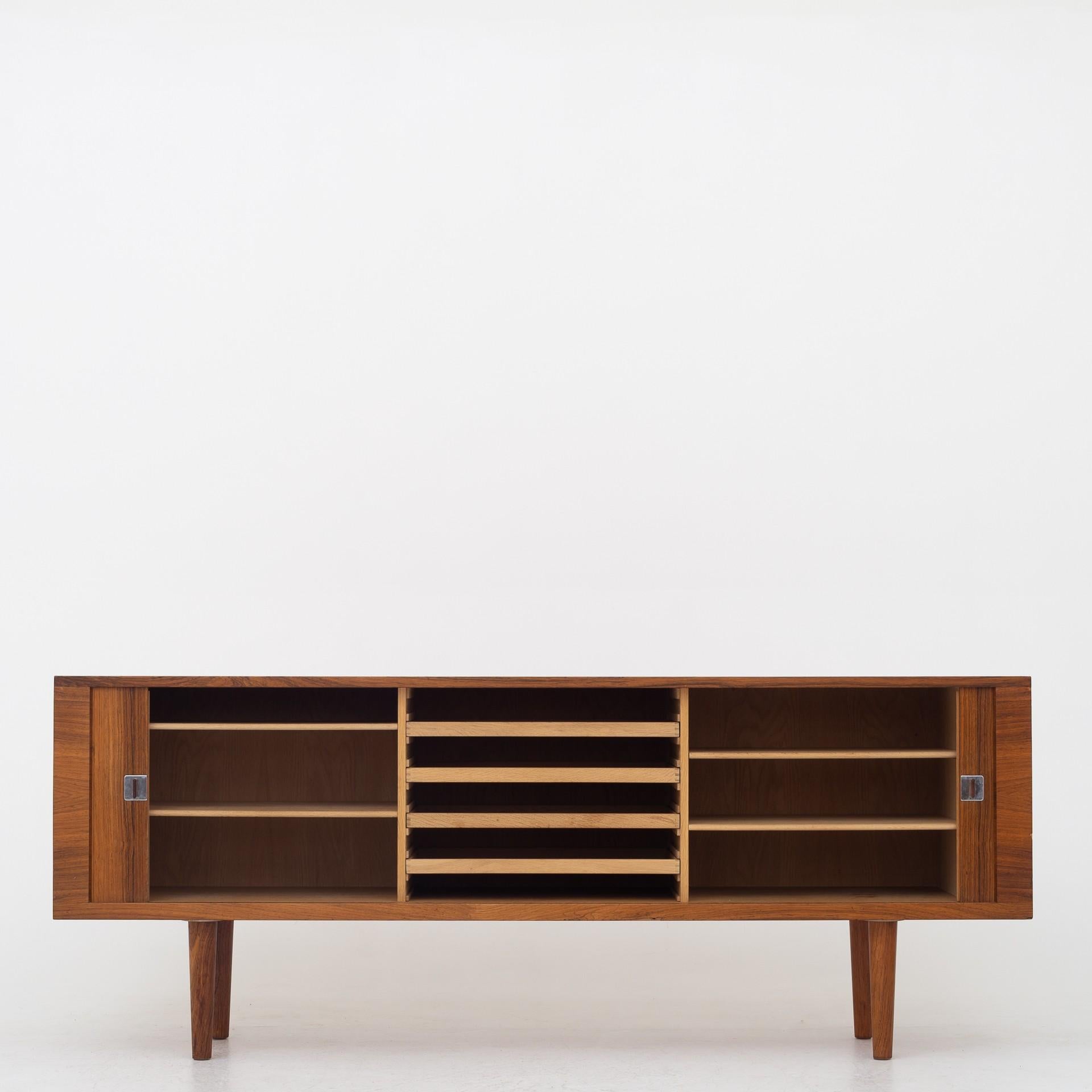 RY 25-sideboard in rosewood with round legs and two tambour doors. Maker Ry Møbler.