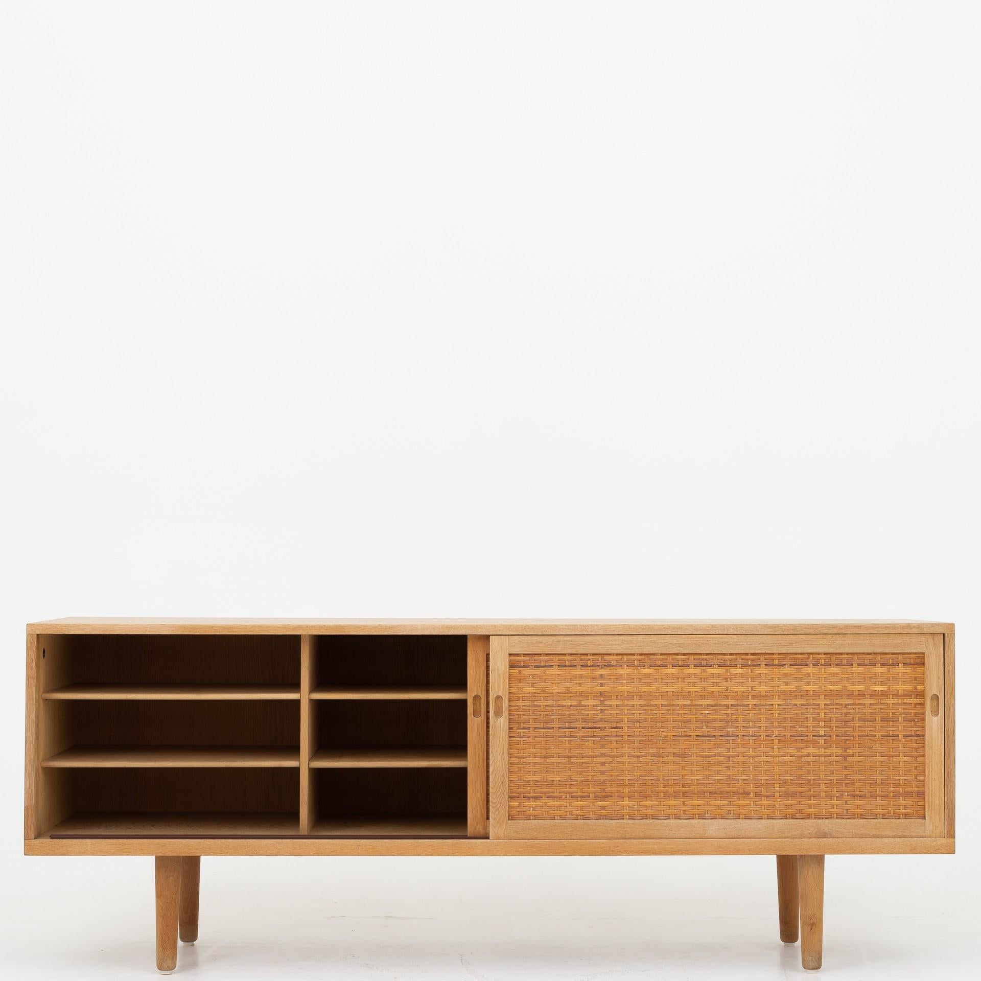 RY 26 - Sideboard in oak with two doors in cane and interior. Maker Ry møbler.