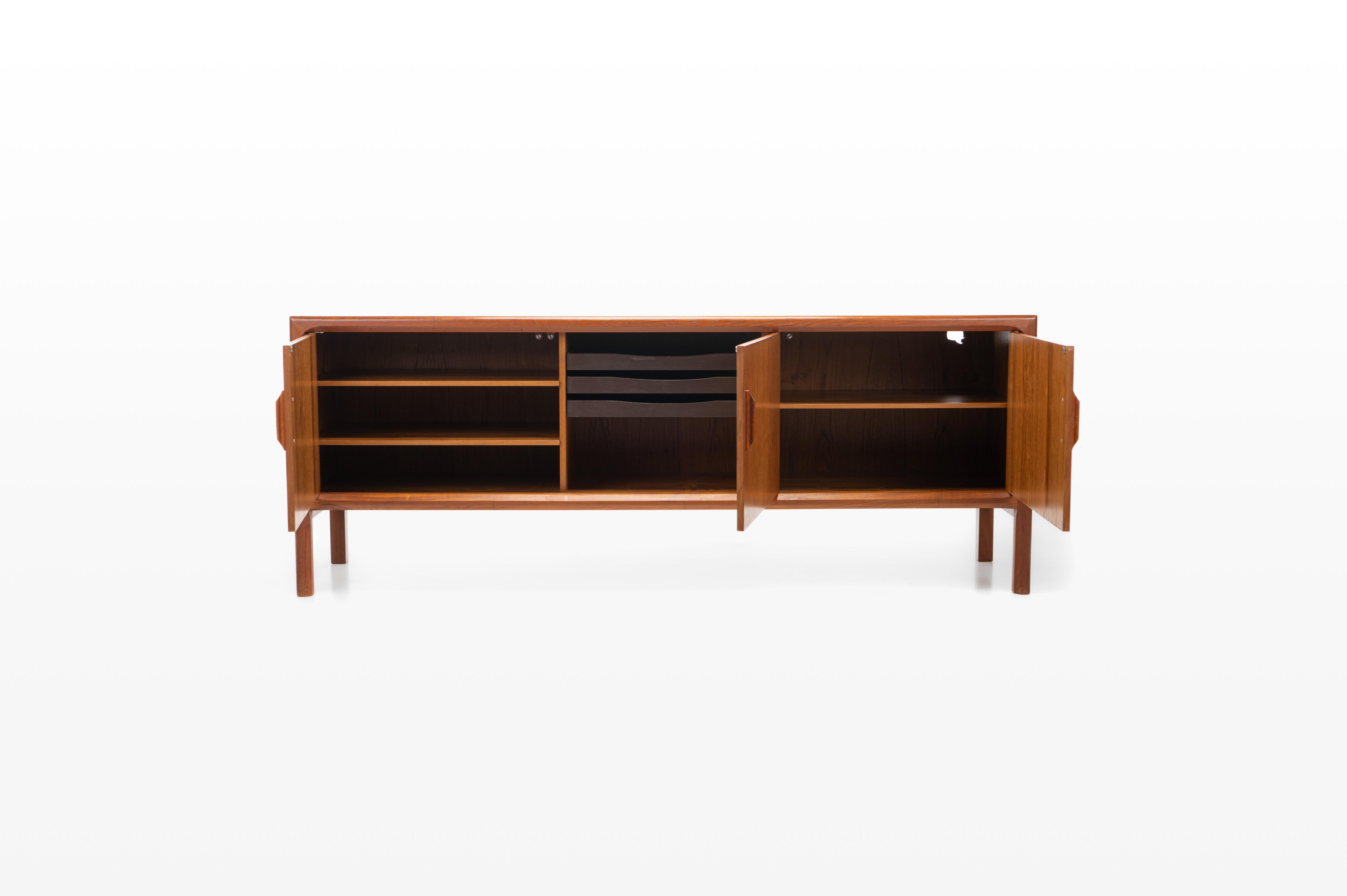 Vintage teak sideboard with three doors and plenty of storage space. Designed for Faarup Mobelfabrik in the 1960s. Marked by the producer.
 