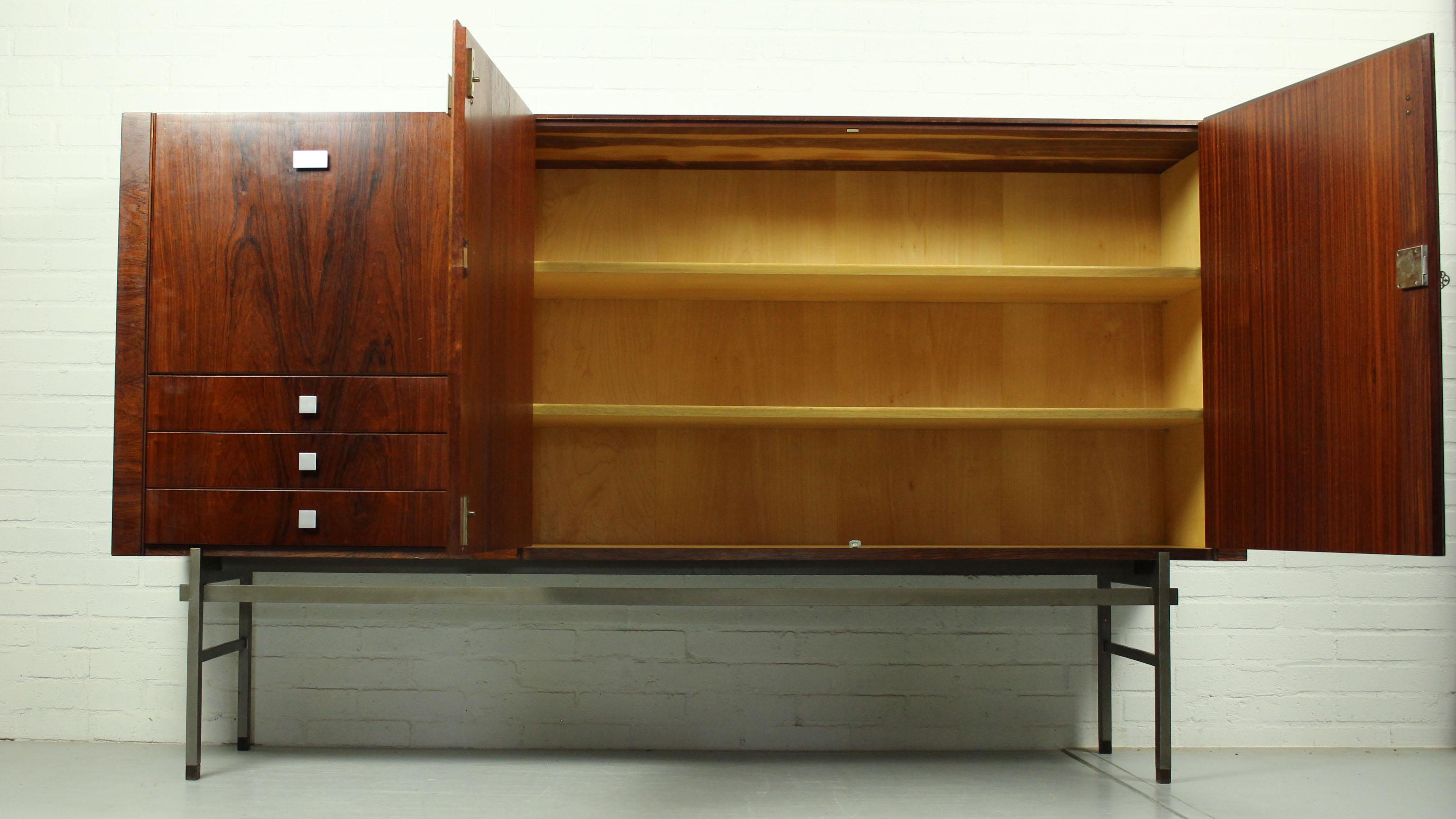 Beautiful credenza by famous designer Louis van Teeffelen for WéBé, 1960s. This Minimalist rosewood sideboard is often attributed to designer Alfred Hendrickx for Belform, but is actually model 317 by Louis van Teeffelen. The cabinet has three