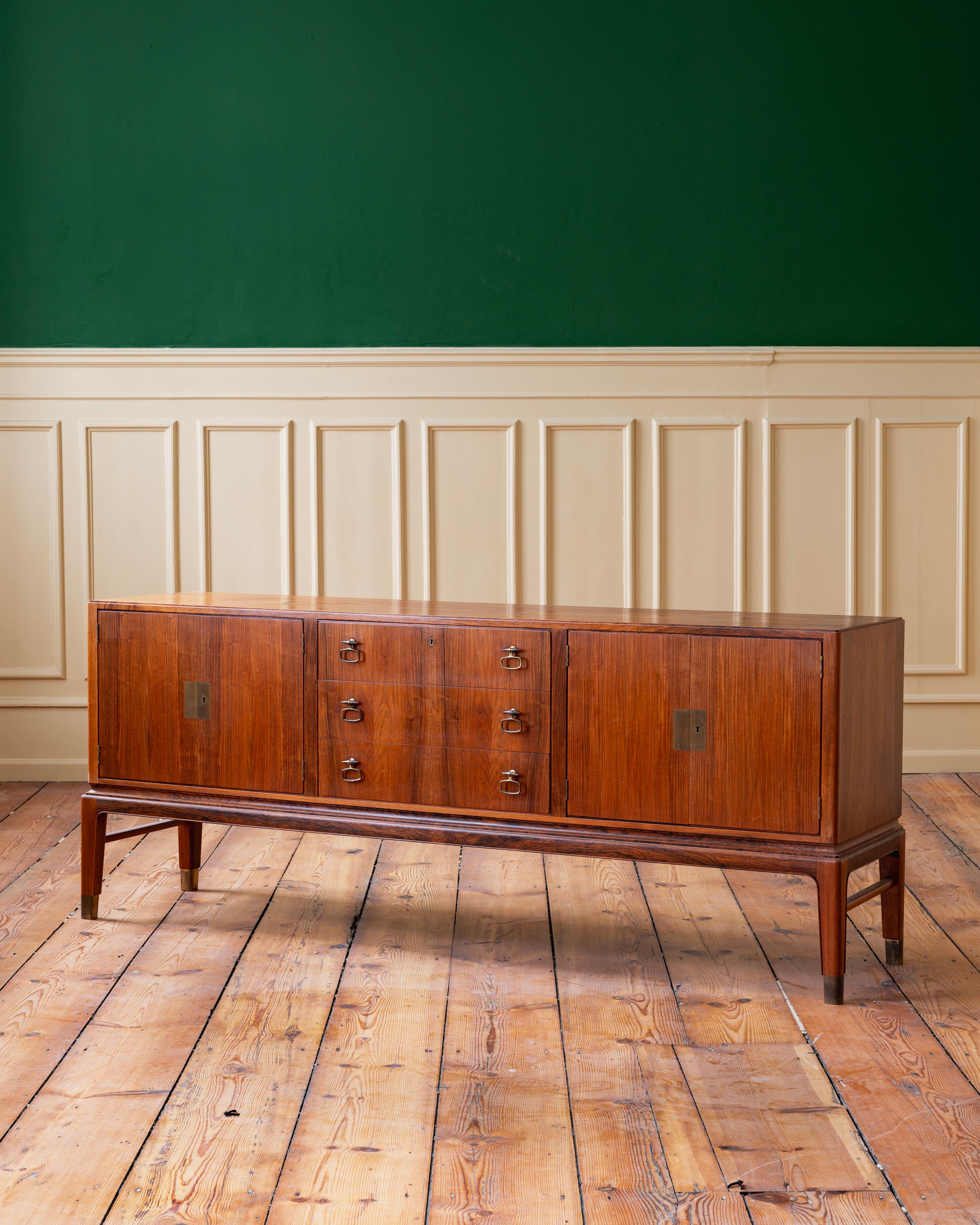 Sideboard by Lysberg, Hansen & Therp in jacaranda veneer with oak interior and brass handles and details. Plaque to interior reads: Kongelig Hofleverandor, (Royal Court supplier) ca 1950-60s Denmark.